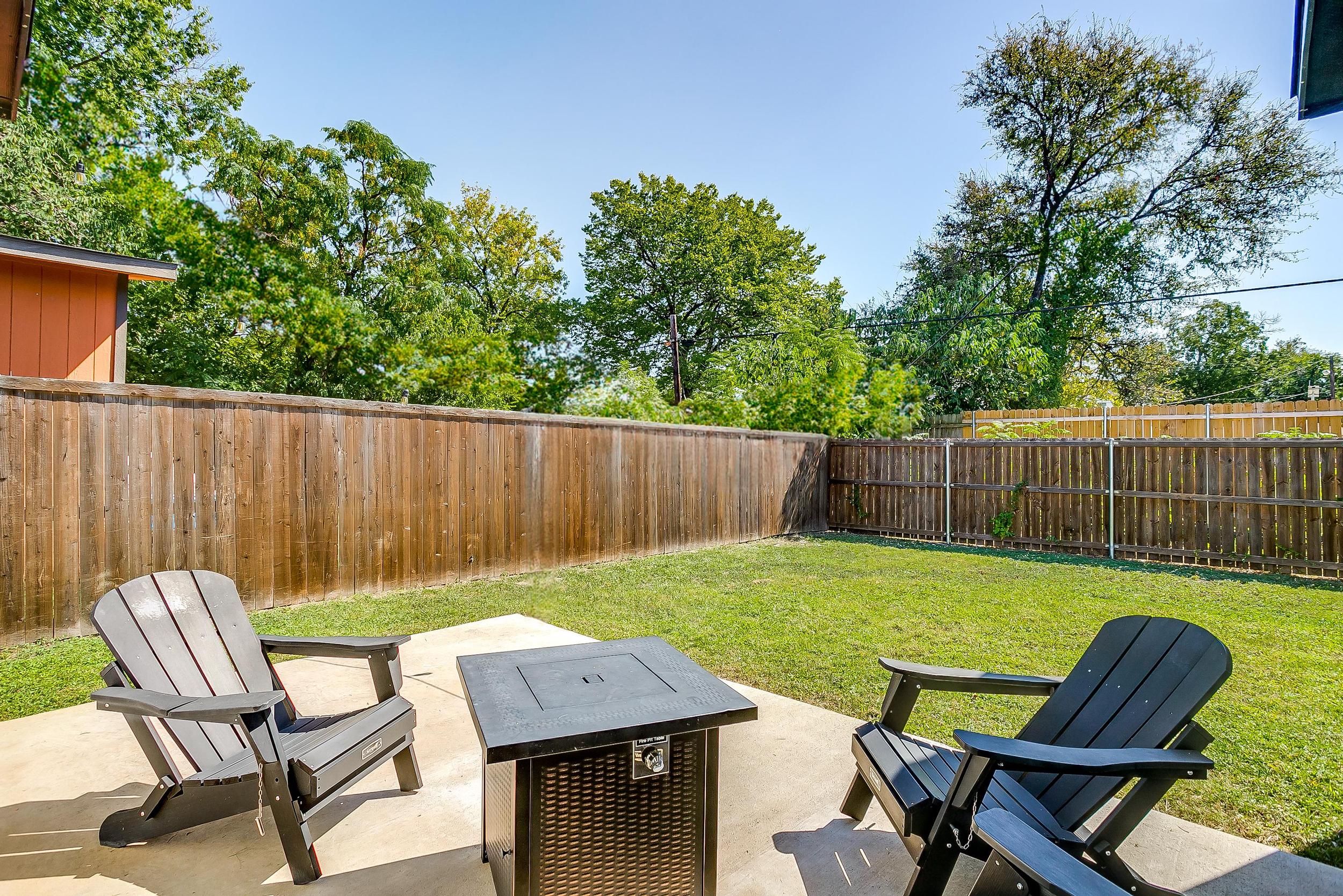 Firepit and chairs create the perfect backyard hangout zone.