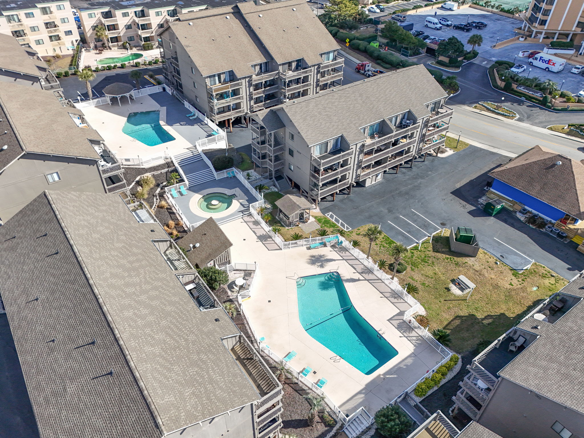View of two pools & hot tub with oceanview, walk to Flip Flops Bar & Grill and other area resturaunts.