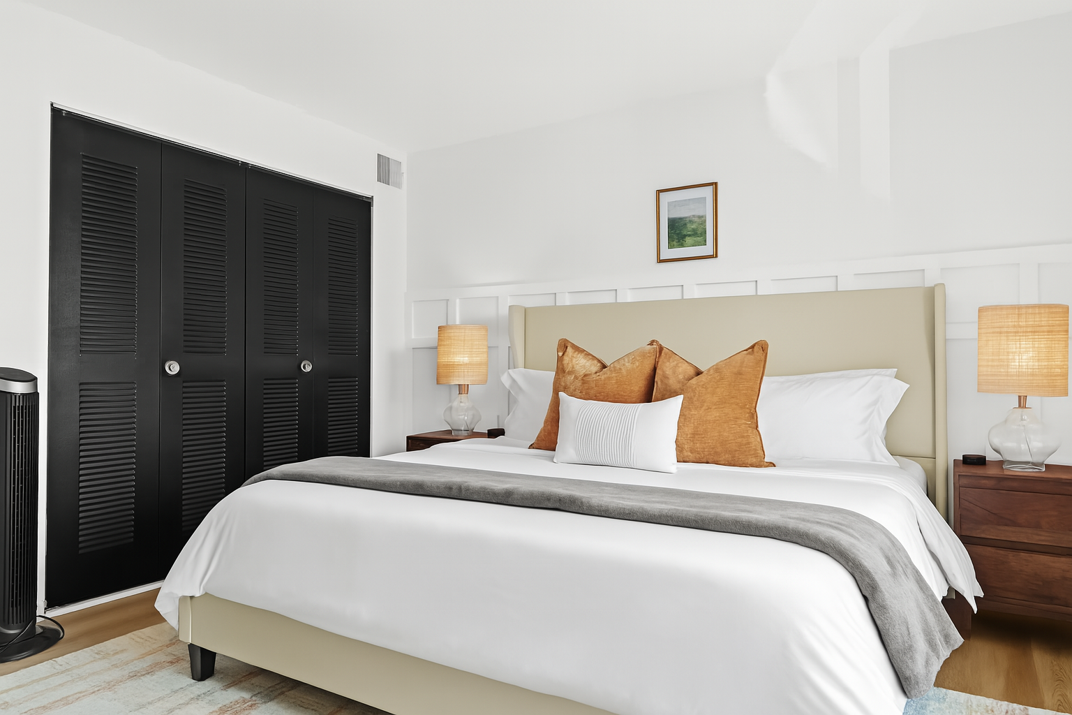 The cozy bedroom features a king bed, ambient lighting, and a designer wood panel wall for added charm.