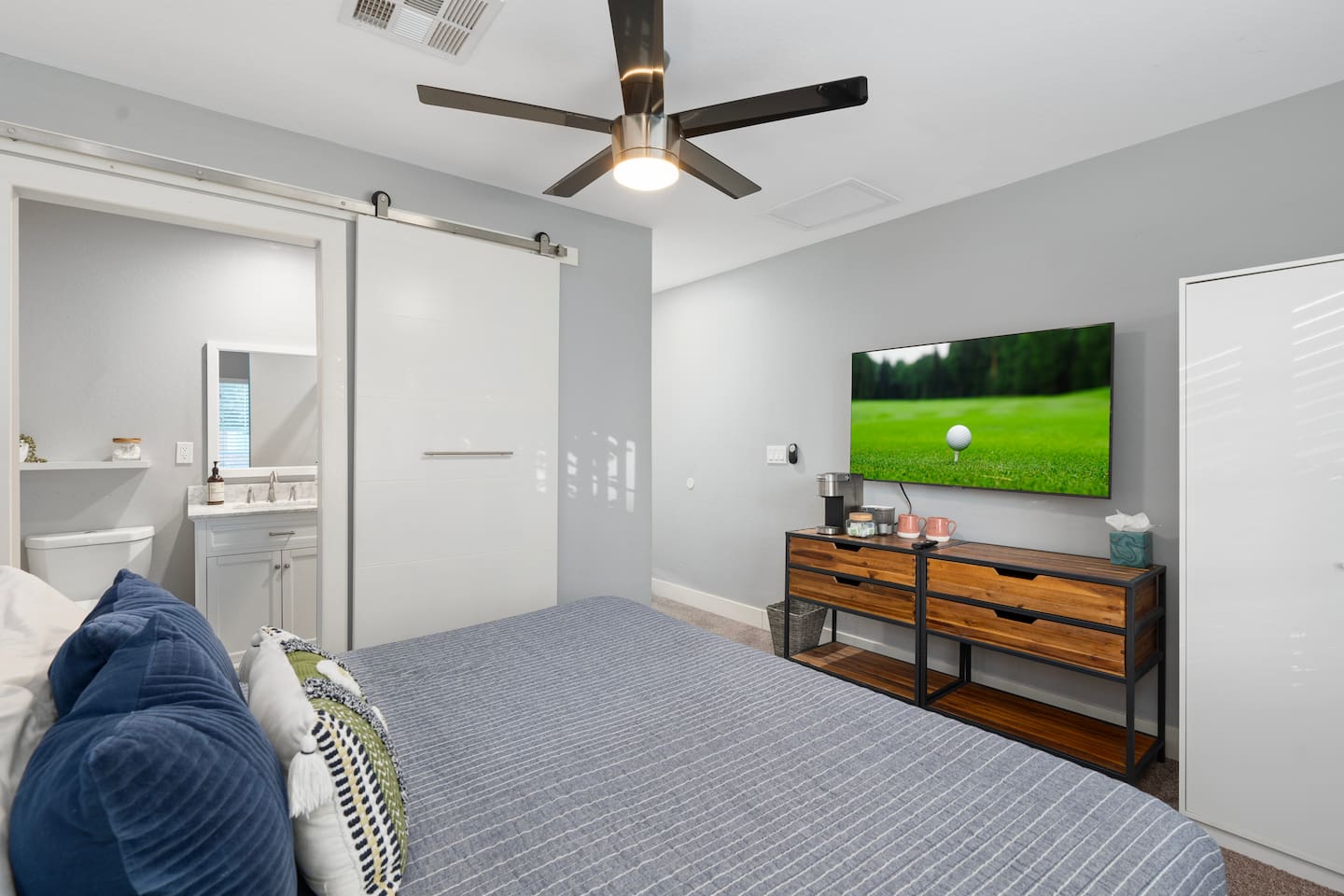 Cozy bedroom featuring a convenient half bathroom, offering added privacy and comfort.