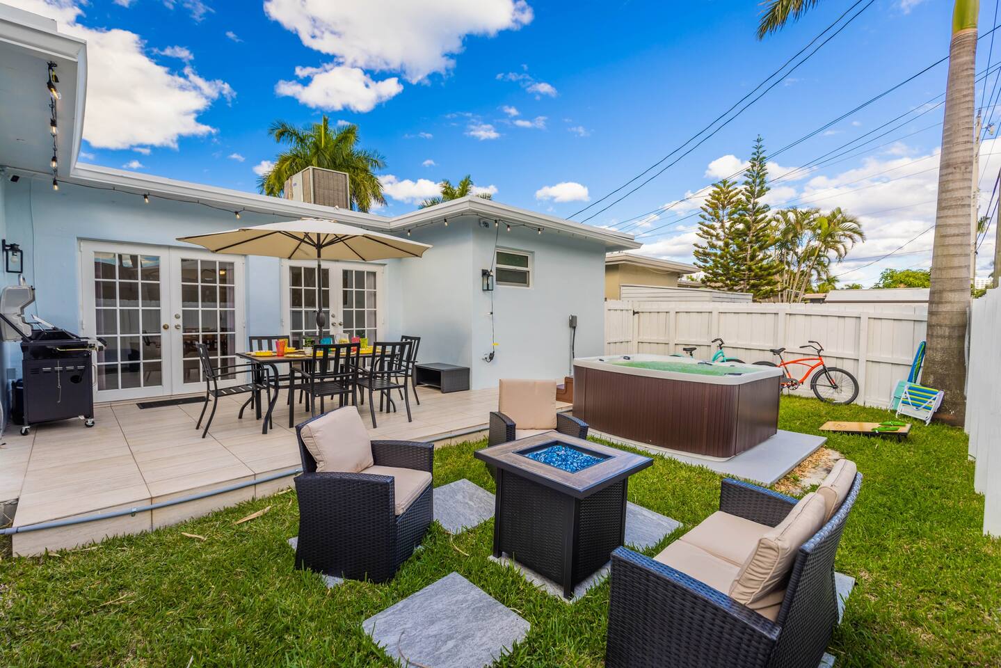 Dine/ BBQ on the patio at the 6 seater dining table and umbrella. Or relax in the new 6 seater hot tub. For those chilly nights, enjoy sitting around the gas powered fire pit lounging areas. The space lit up by remote controlled string lights.