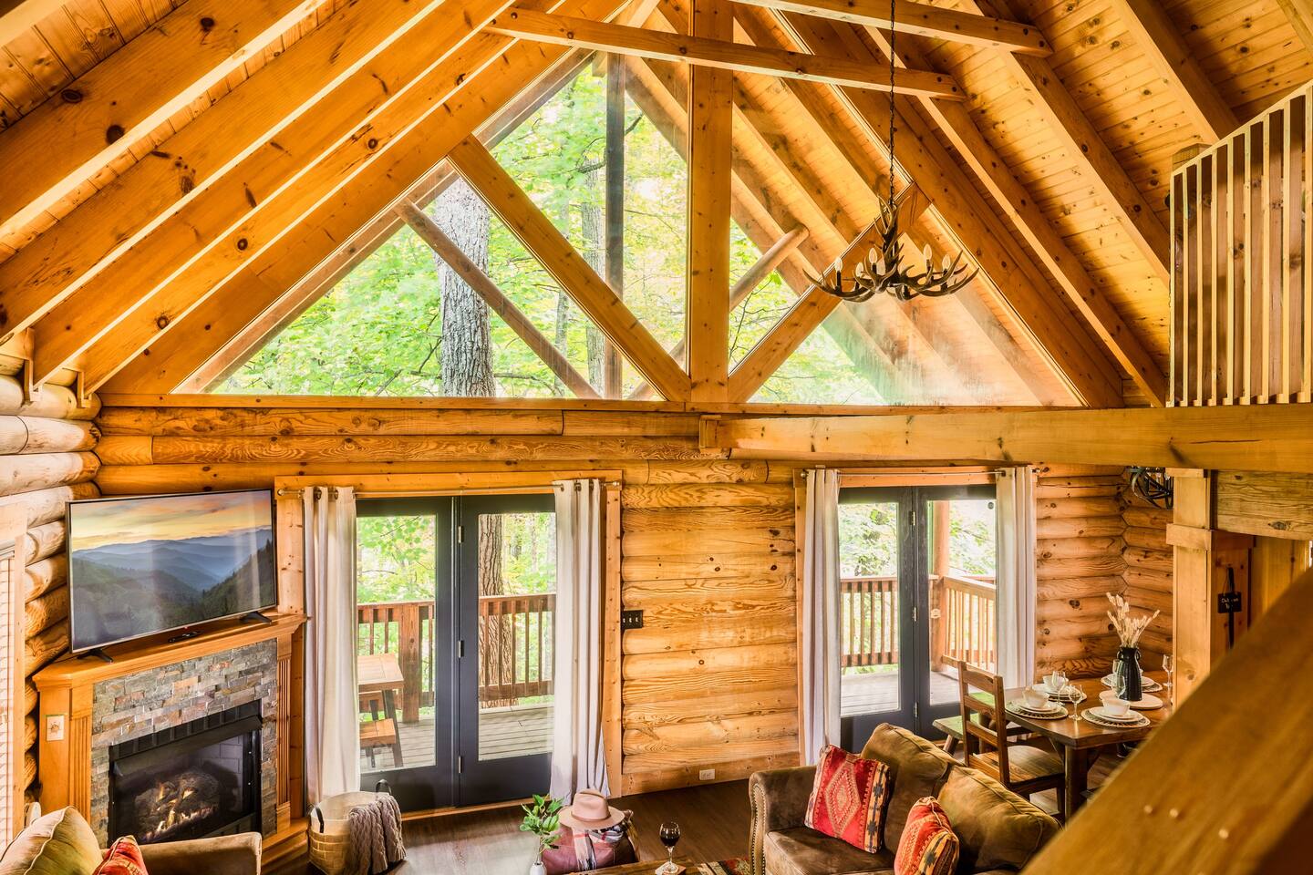 Cozy living area with gas fireplace and forest views.