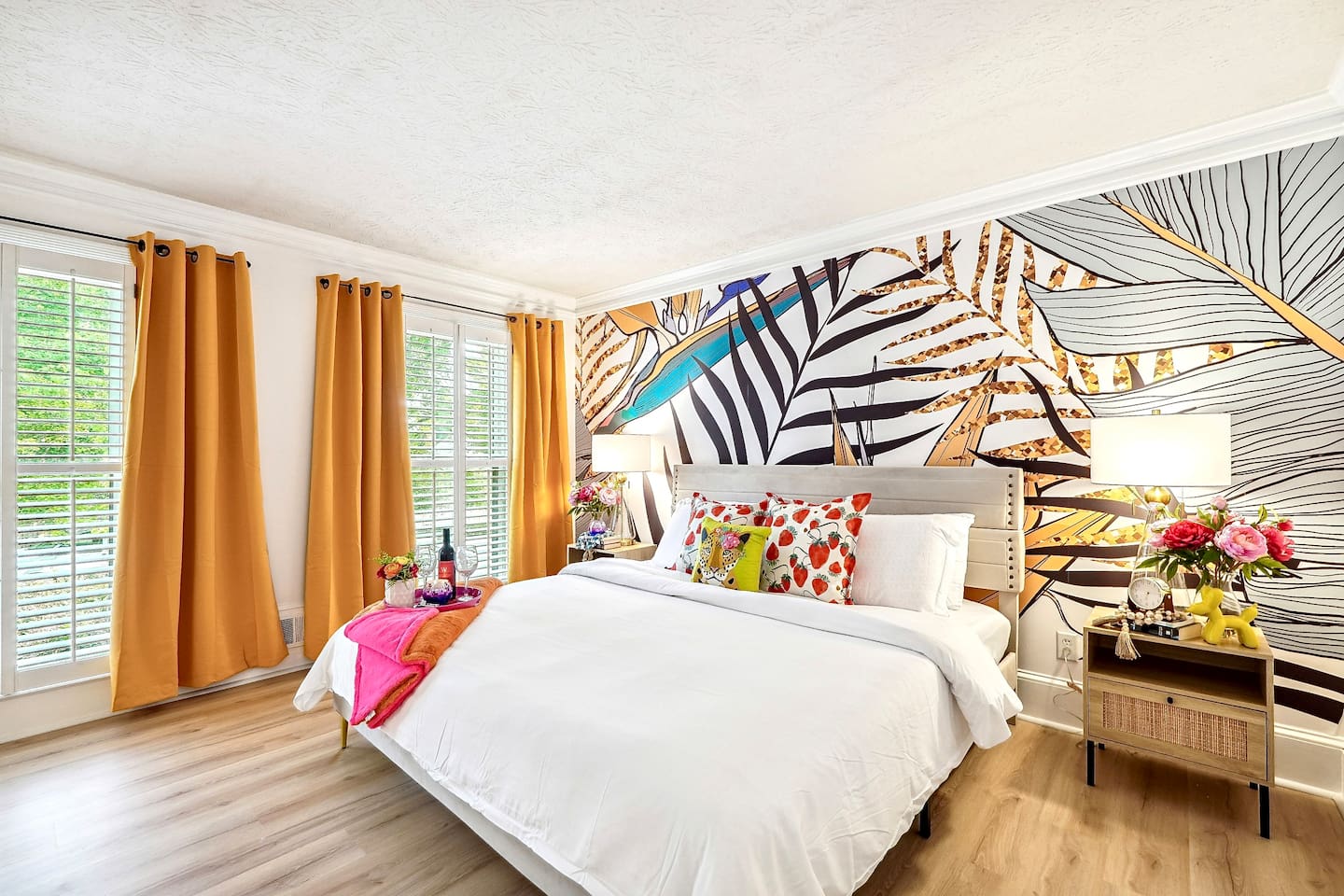 Bedroom 1 is located on the main level and features a king-size bed, TV, and a no ensuite bathroom. A nearby half bathroom is available for guest use.