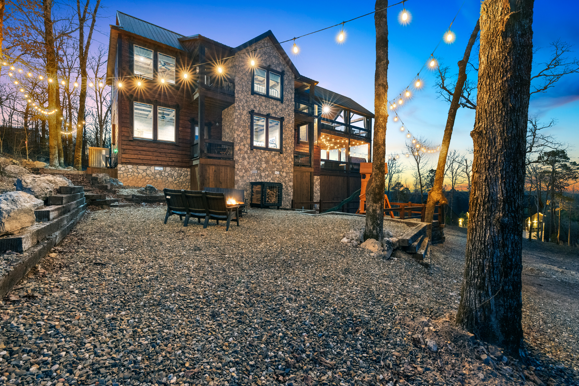Stunning luxury cabin exterior with glowing evening lights and peaceful forest surroundings