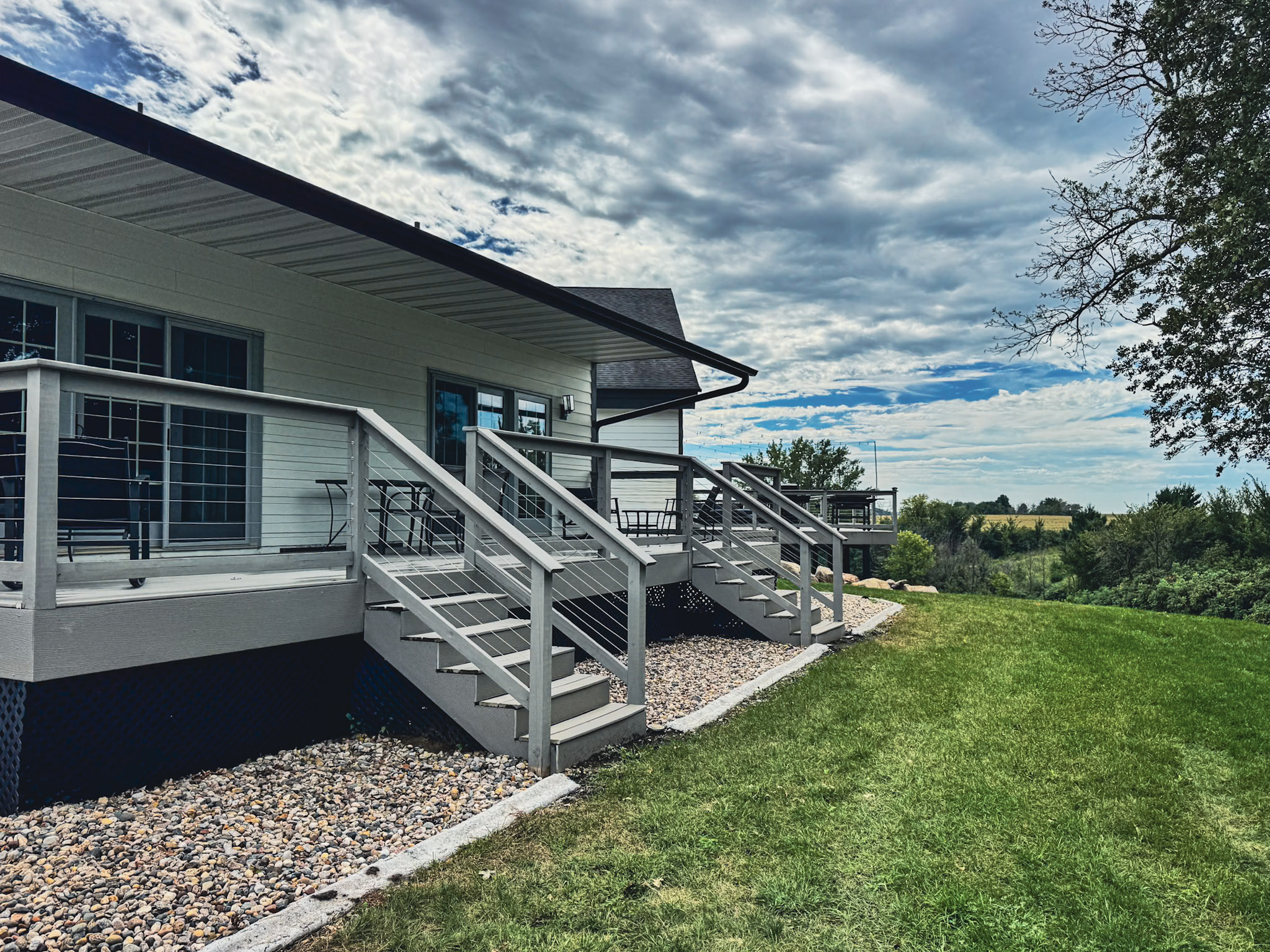 Rear deck and steps overlooking the lawn and countryside.