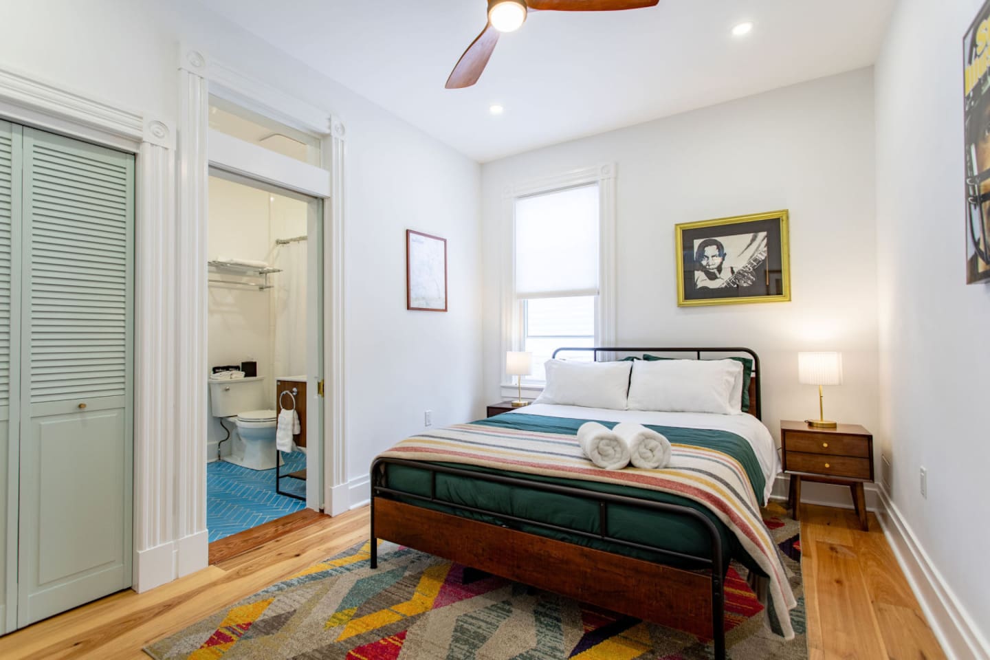 A bedroom showcasing a comfortable bed, with a clear view of the attached bathroom, creating a convenient and open layout that enhances the flow of the space.