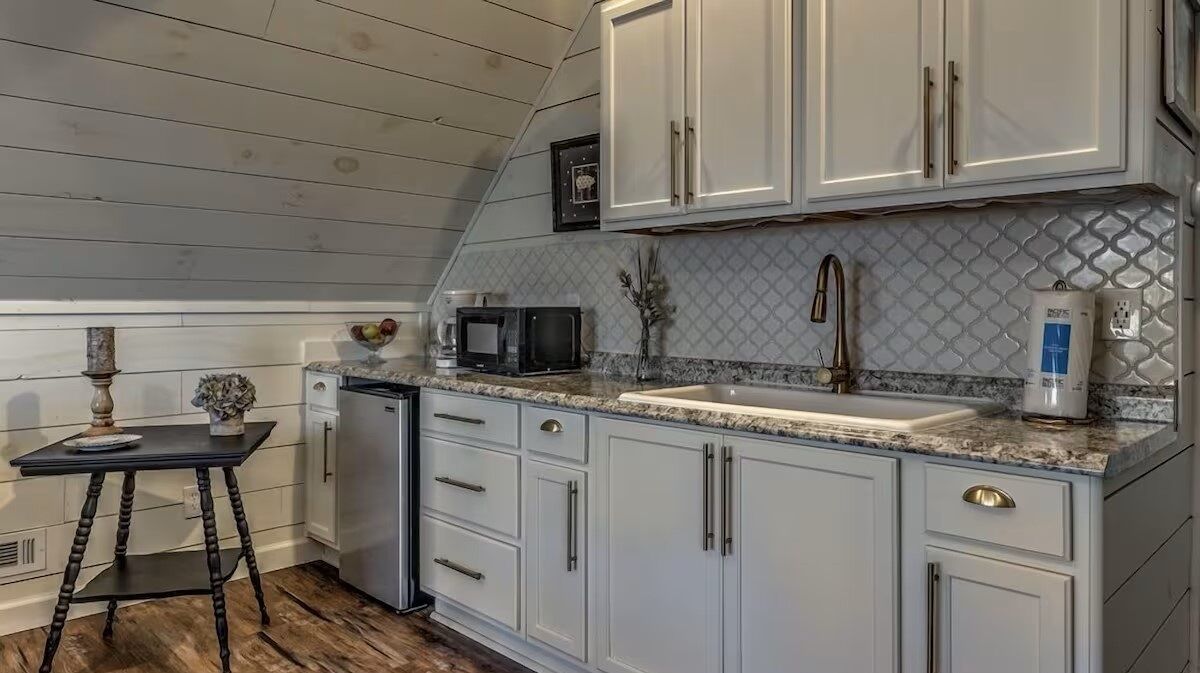 Private kitchenette in the detached guest suite above the garage, complete with a microwave, farmhouse sink, and mini fridge