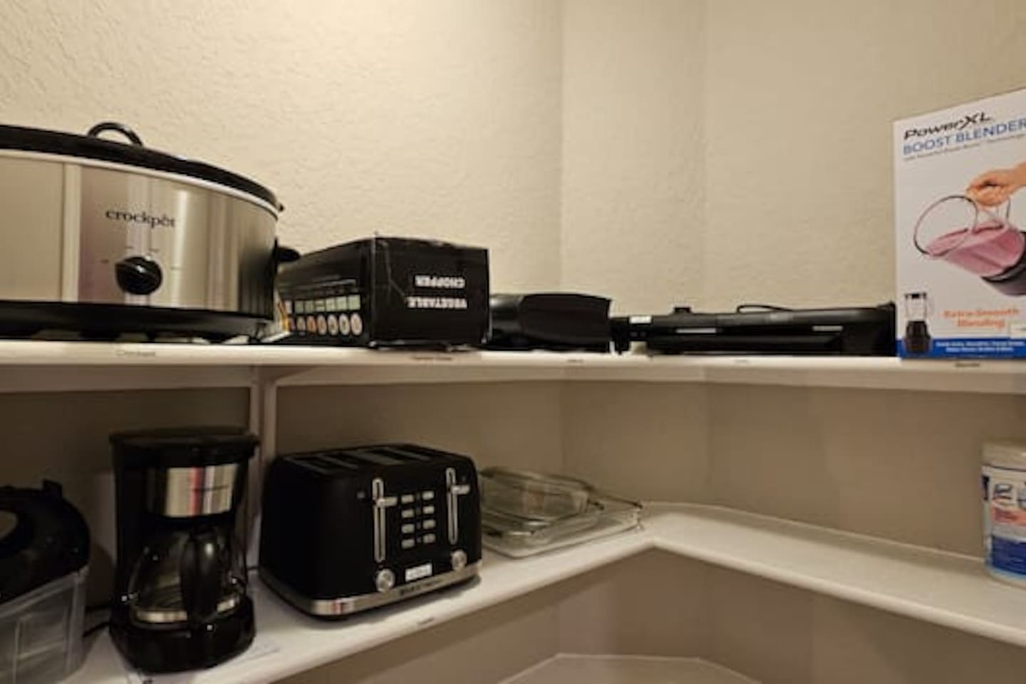 Chef-ready kitchen featuring extra appliances like blender, crock pot, and electric grill, plus generous pantry storage, cookware, and all dining essentials.