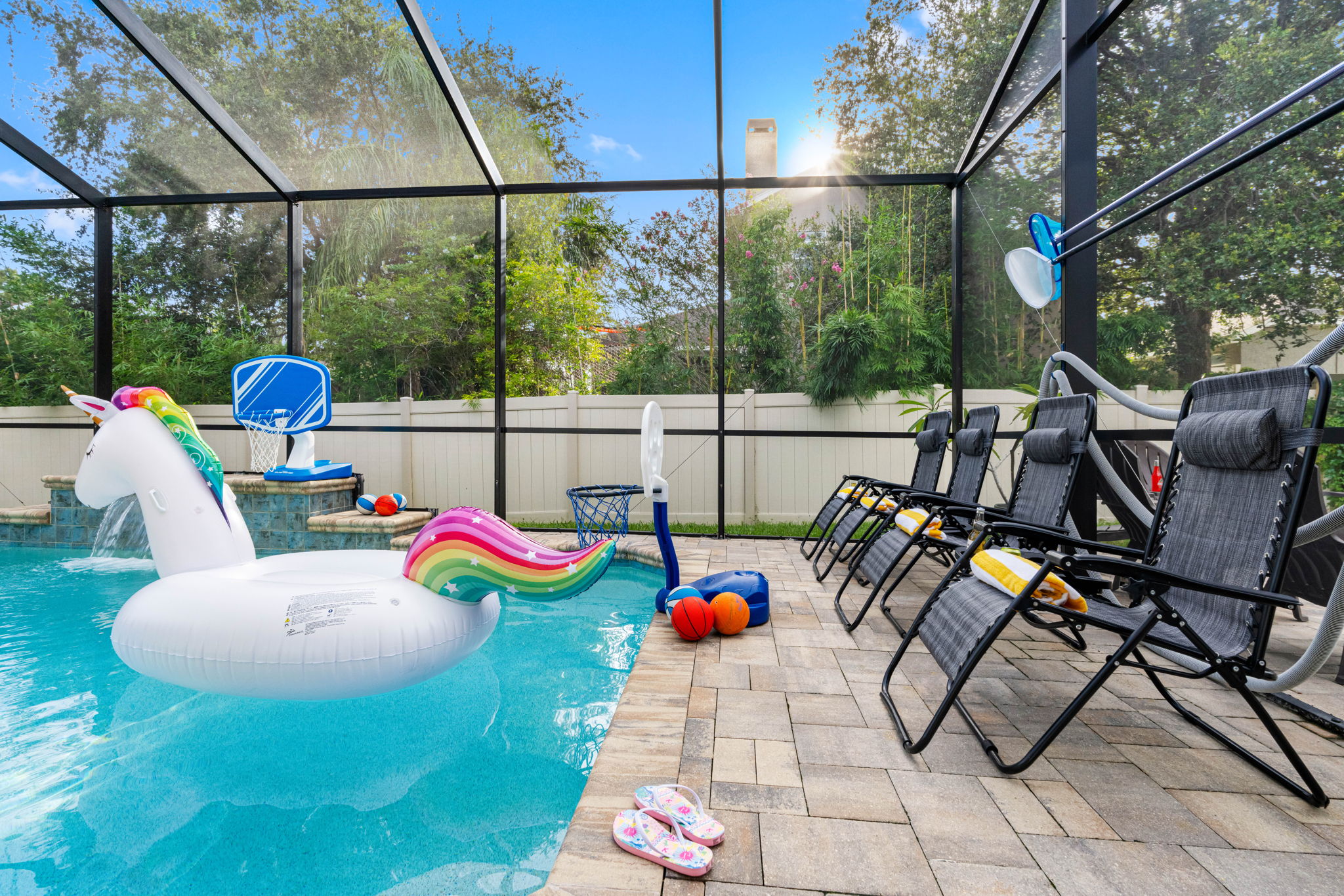 Enjoy the outdoors without the hassle—this entire pool area is enclosed with a full-screen structure, keeping bugs and debris at bay while still letting in plenty of sunlight and fresh air.