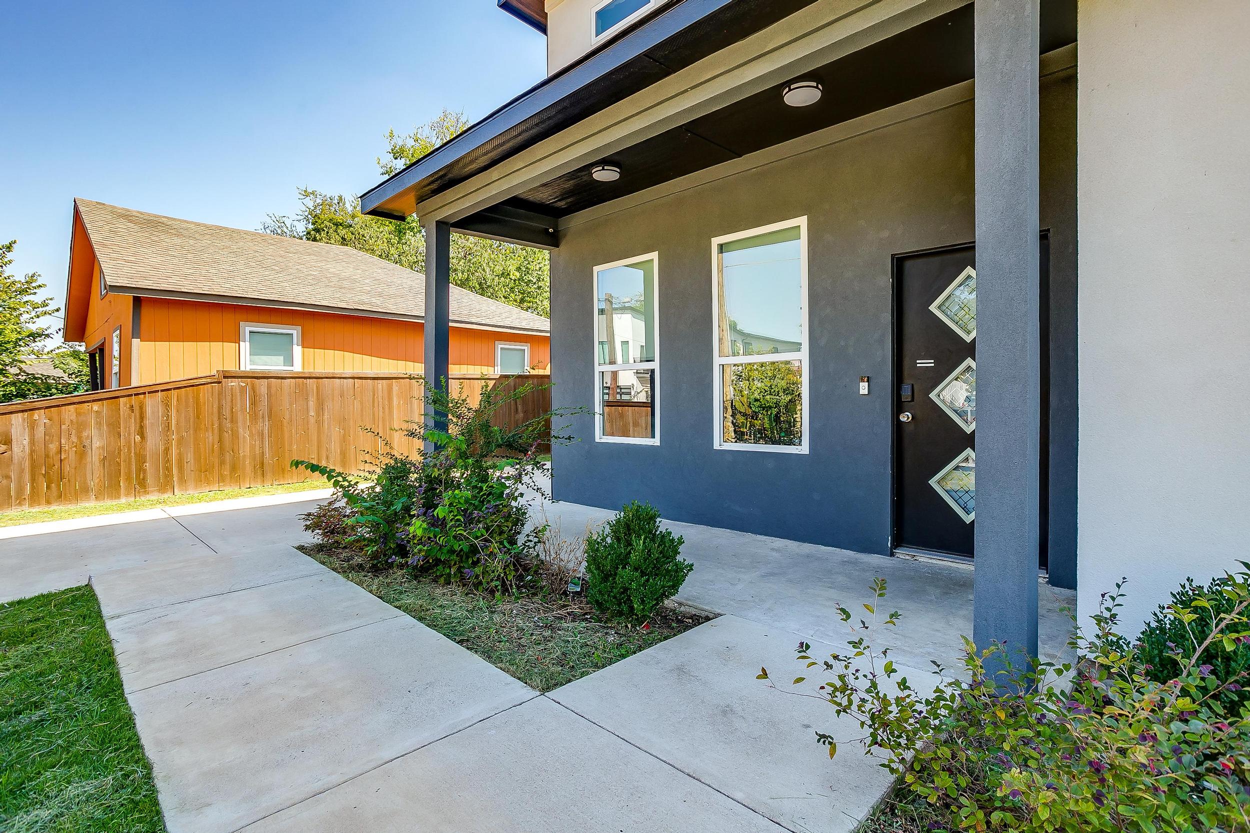 Side view of the home with private patio and easy yard access.