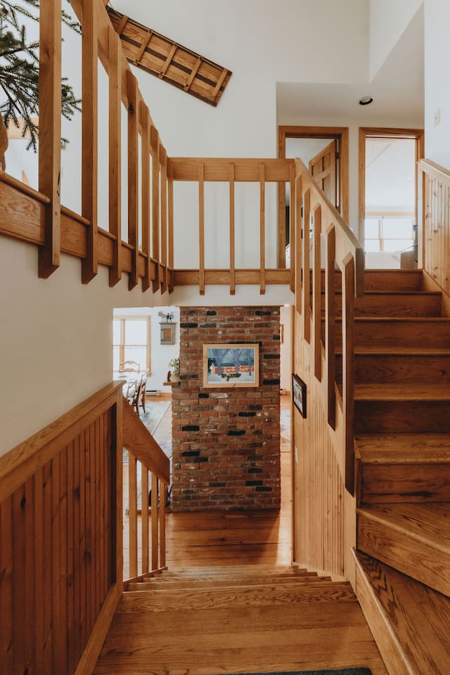 View from the front door with a short staircase going down to the main level and up to the upper level