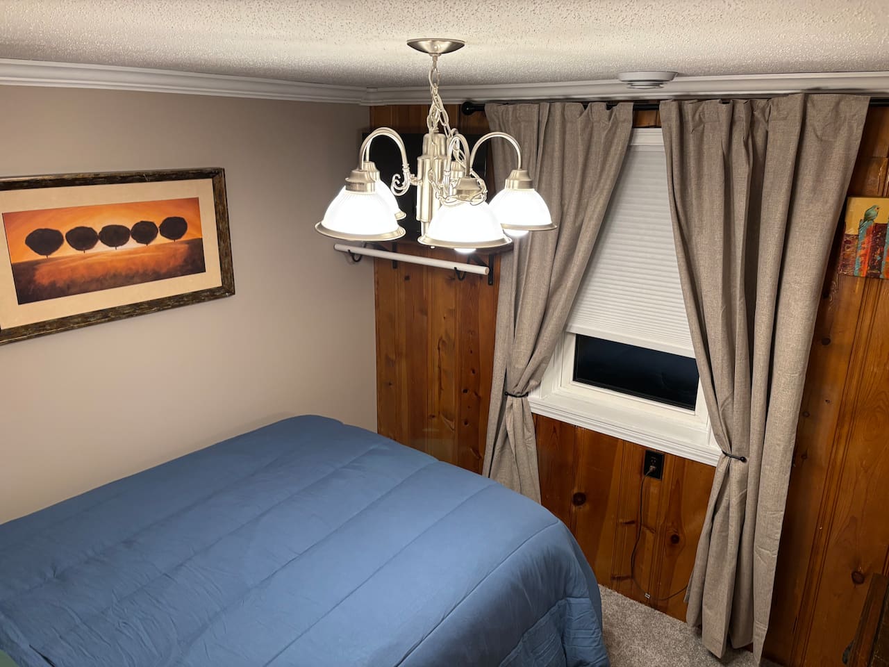 Light filtering shade allows for privacy, without sacrificing light. Close curtains for darkening and temperature comfort. No closet available in this room, but it offers a clothing rod to hang some things if needed. Located below the TV.