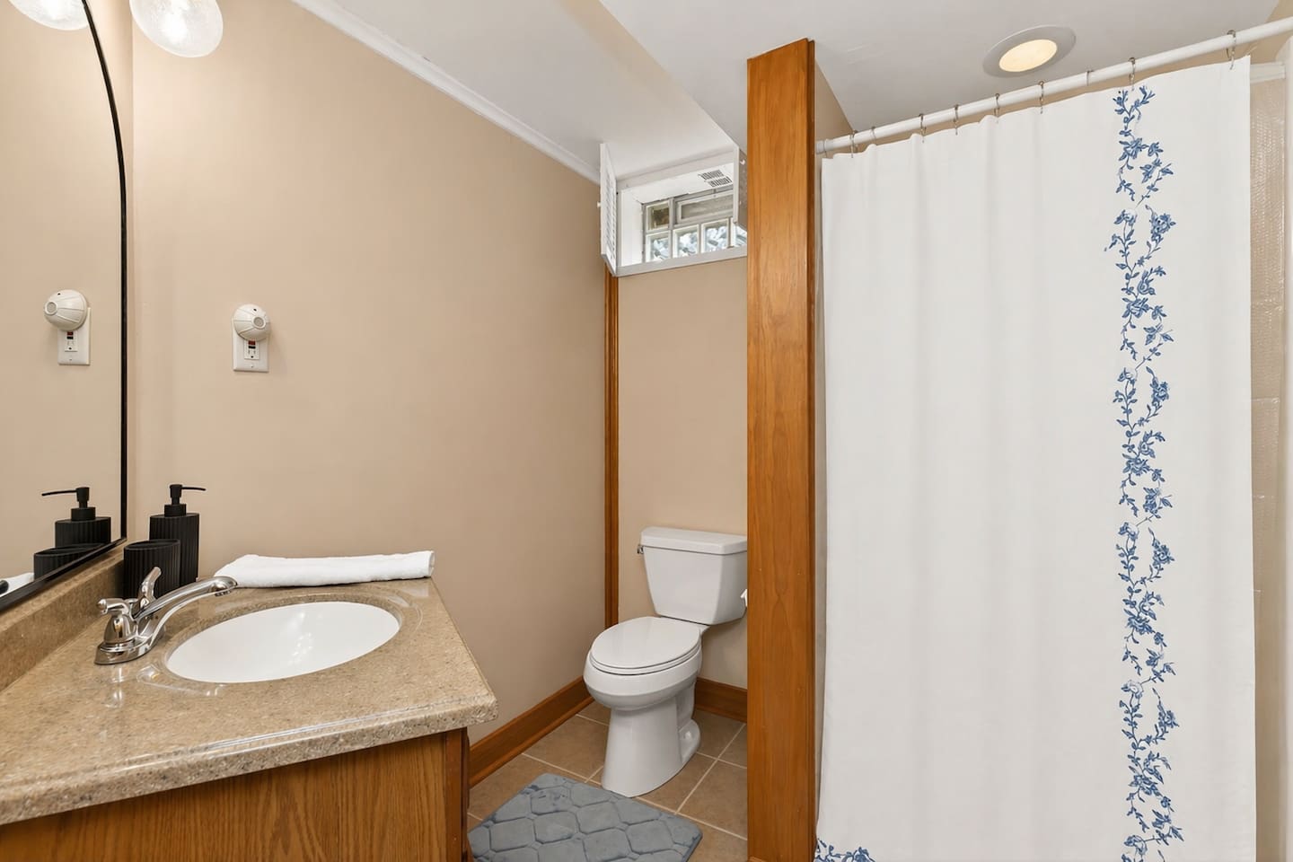 “Enjoy this clean and bright downstairs bathroom with a modern vanity and refreshing shower—perfect for recharging after a day of relaxation.”