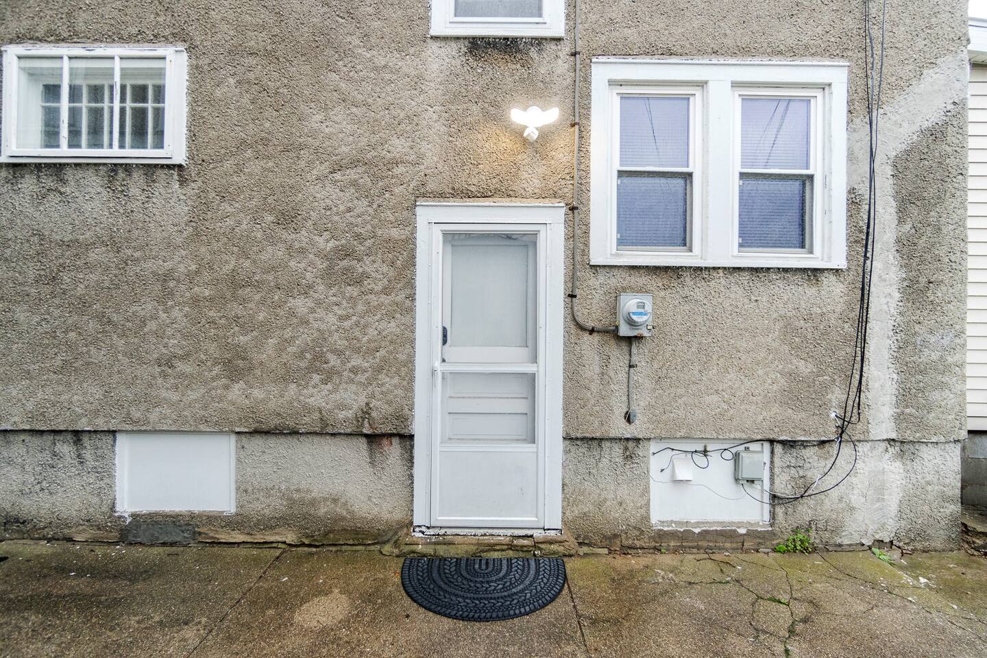 Charming exterior view featuring the entrance door of the house, offering a warm and inviting first impression—highlighting modern design elements and a welcoming atmosphere for guests and residents alike.