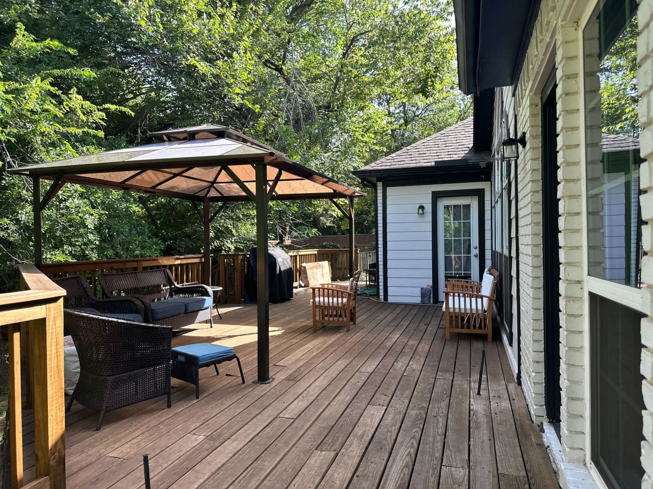 Covered patio with grill for outdoor dining and entertaining.