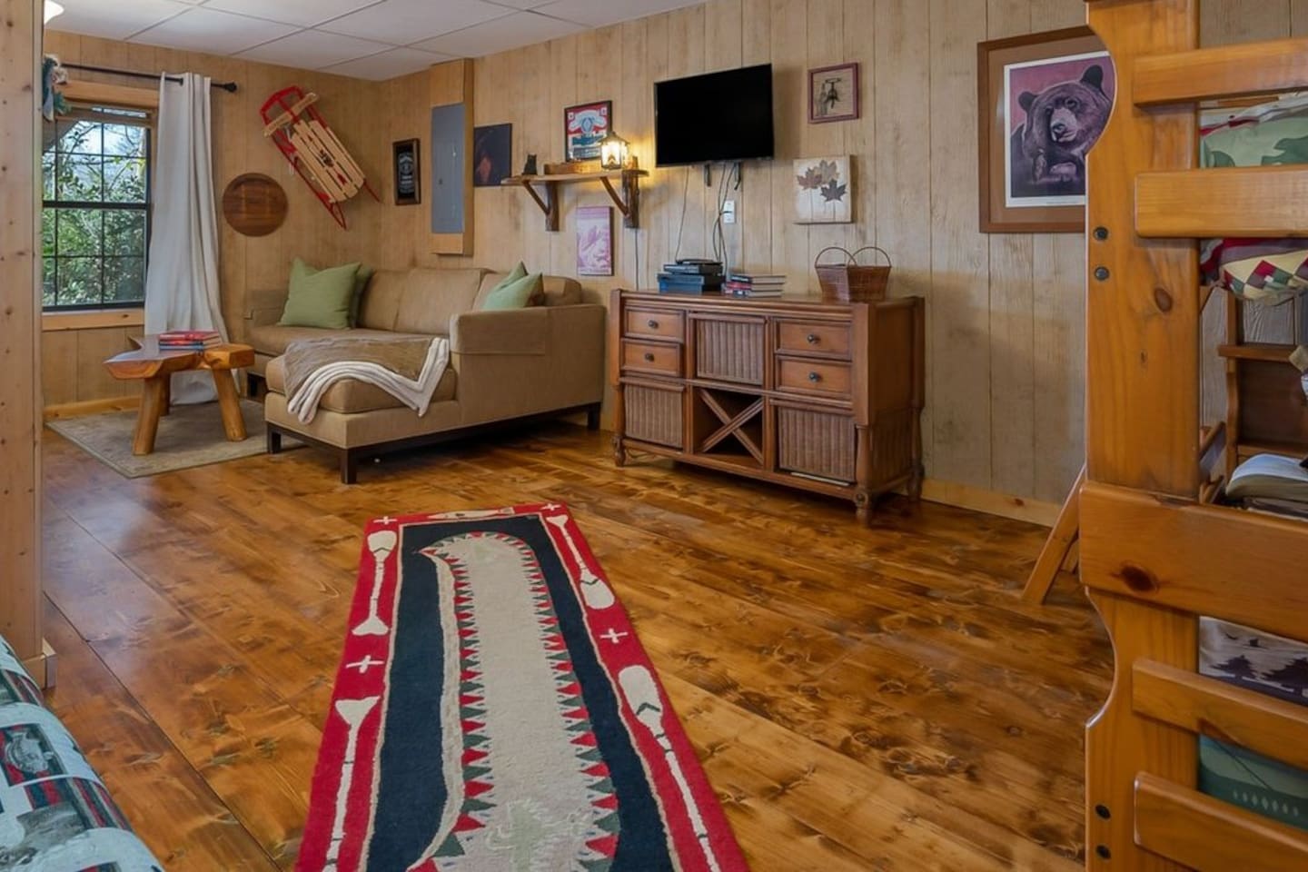 Lower level with pool table, bunk beds, queen futon sleeper and couch. Loer level open to lower deck with lake/mountain views and seating.