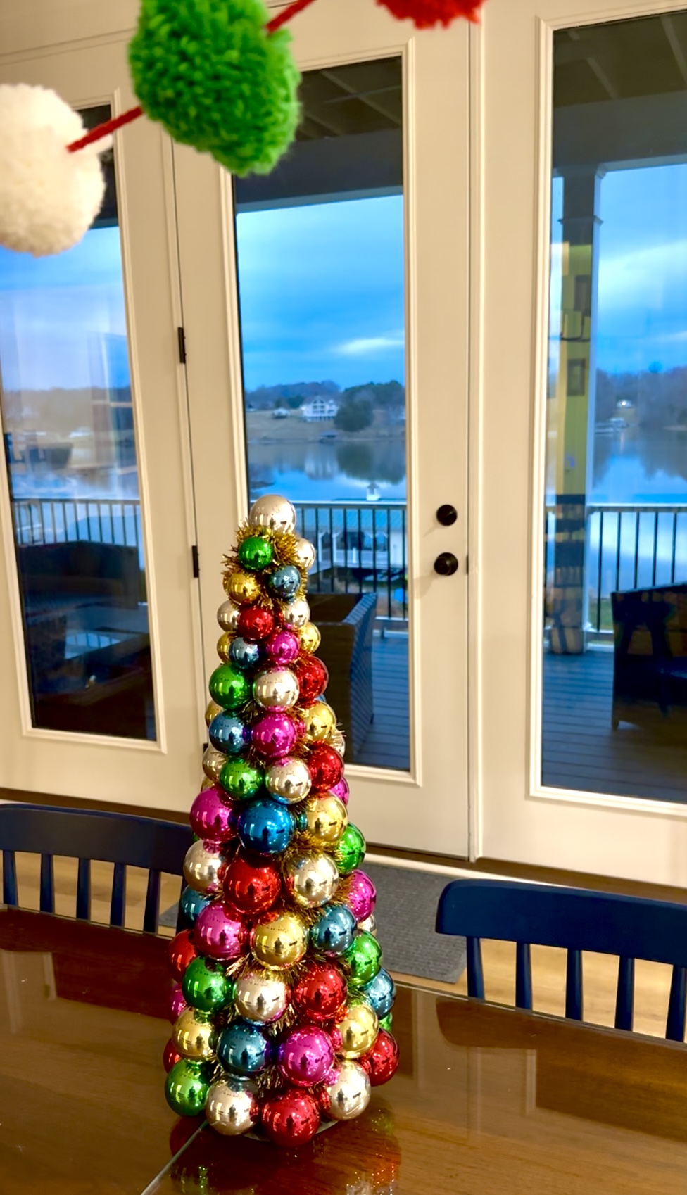 The perfect holiday dining scene—festive décor on the table and stunning lake views just beyond.