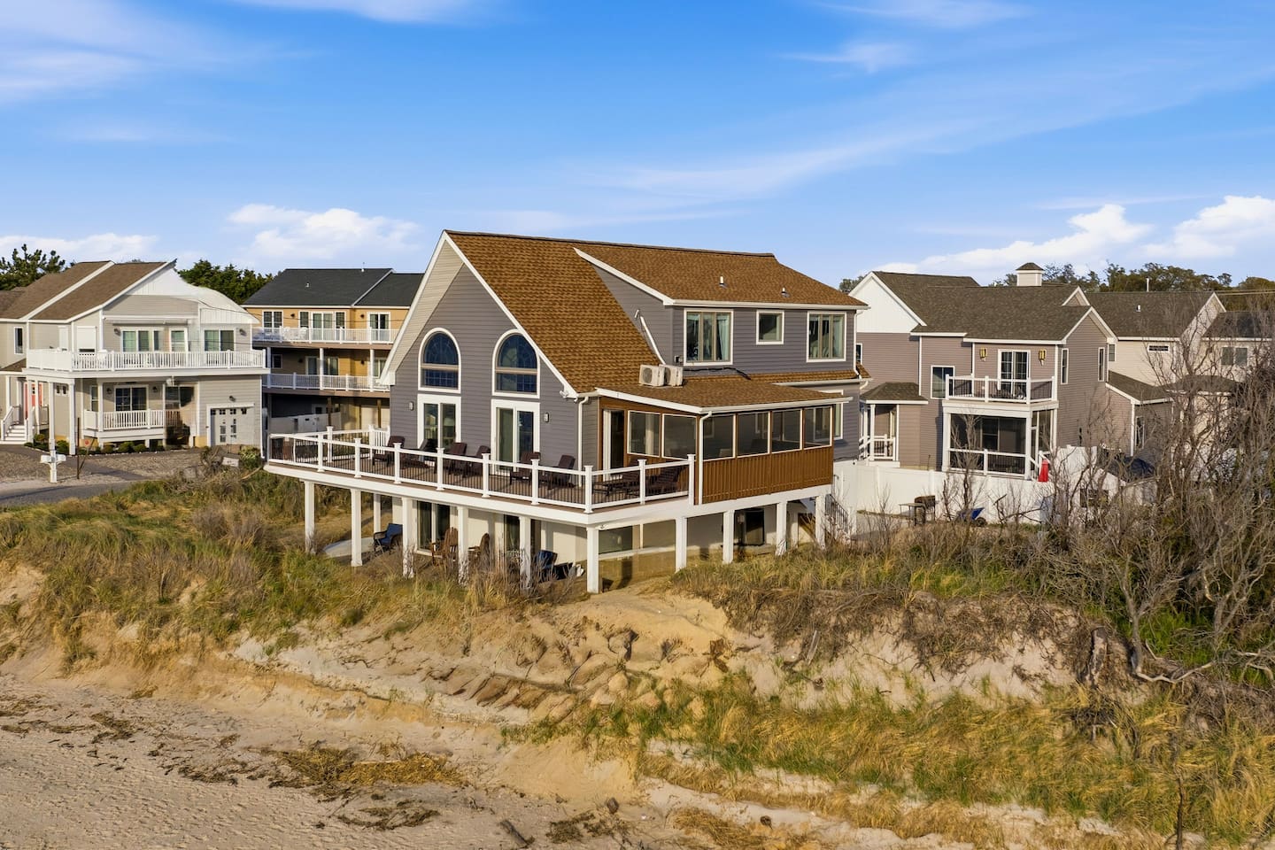 Enjoy the perfect beachfront escape at this stunning property, uniquely positioned for direct shoreline access and sweeping coastal views from its expansive elevated deck.