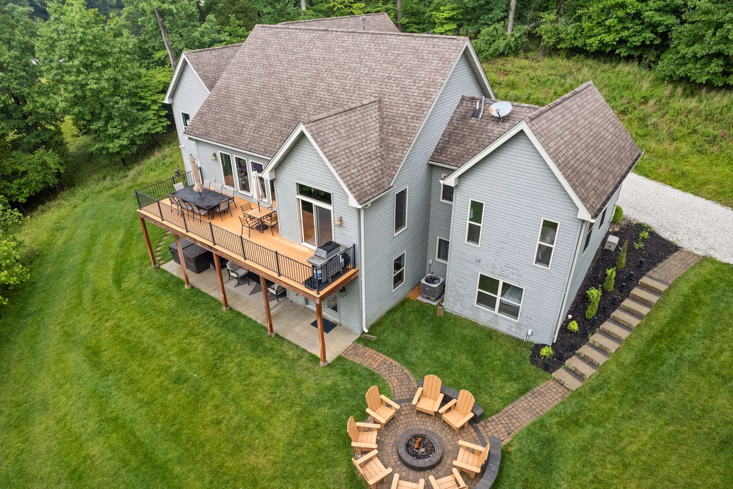 The large house sits on 1.5 acres. Enjoy the outdoors with the fire pit, hot tub, grill, and outdoor seating