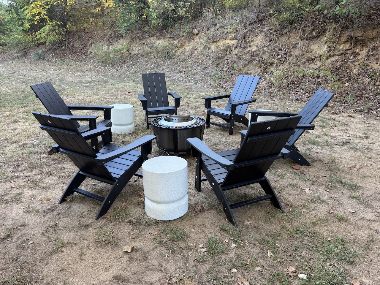 Wood burning fire pit with seating for up to 6, offering a cozy outdoor gathering spot for evenings by the fire, conversation, and relaxation.