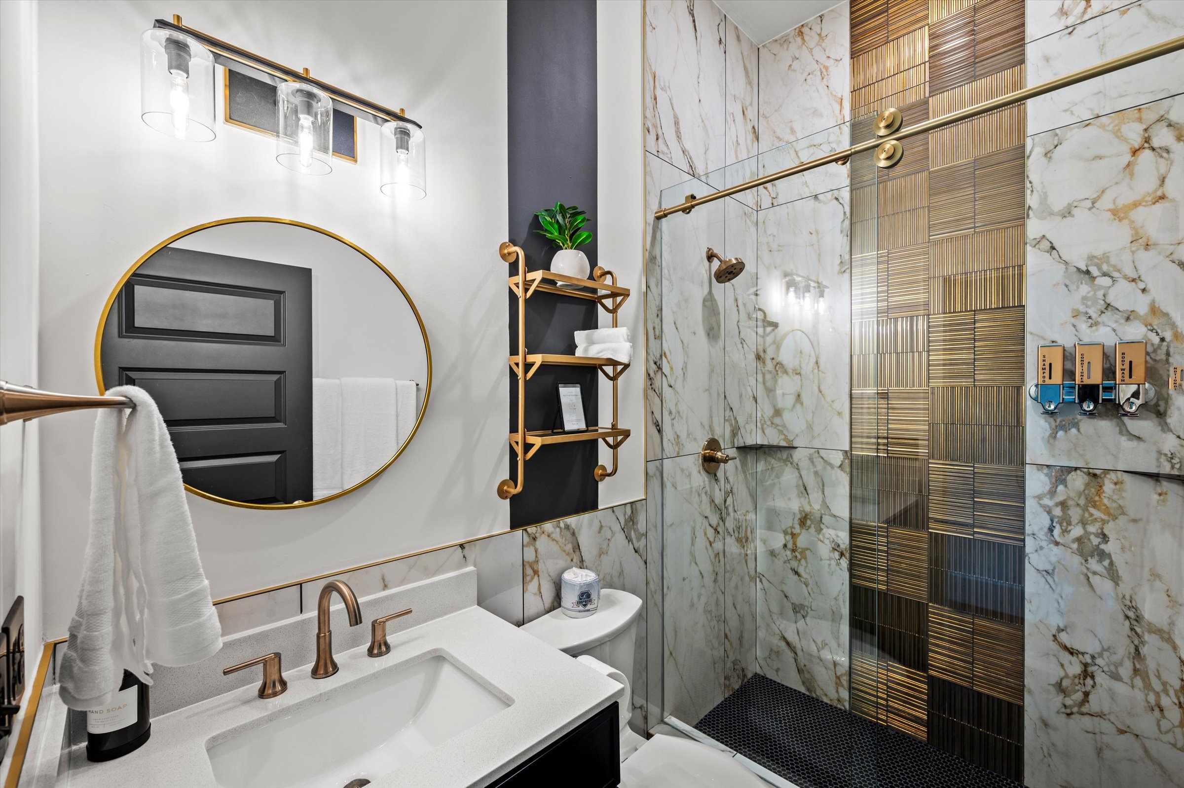A masterfully designed en-suite bathroom, complete with a glass-enclosed walk-in shower and modern finishes.