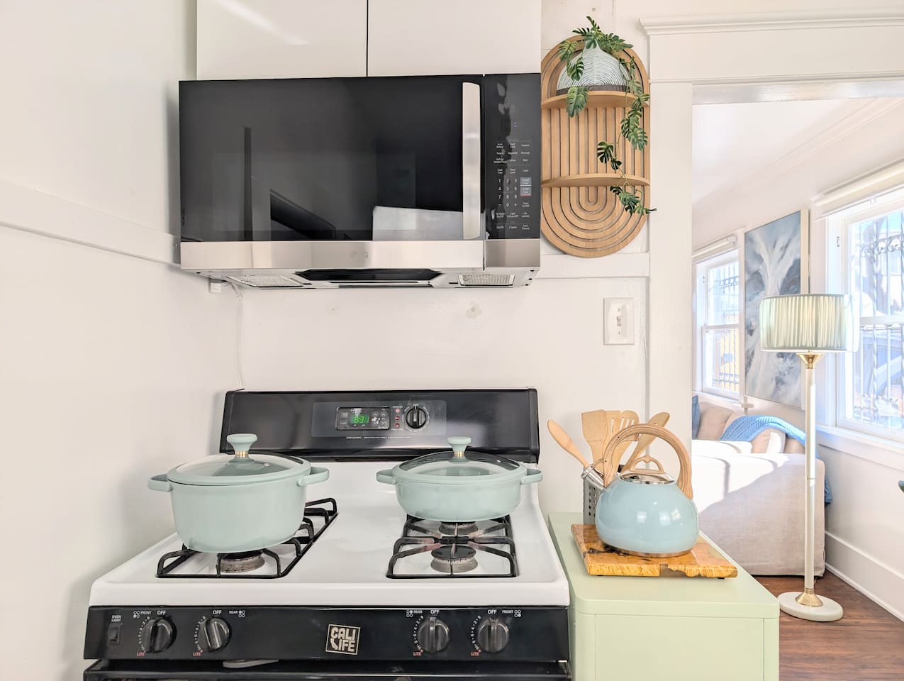 Full kitchen with gas stove, microwave, and cooking essentials.