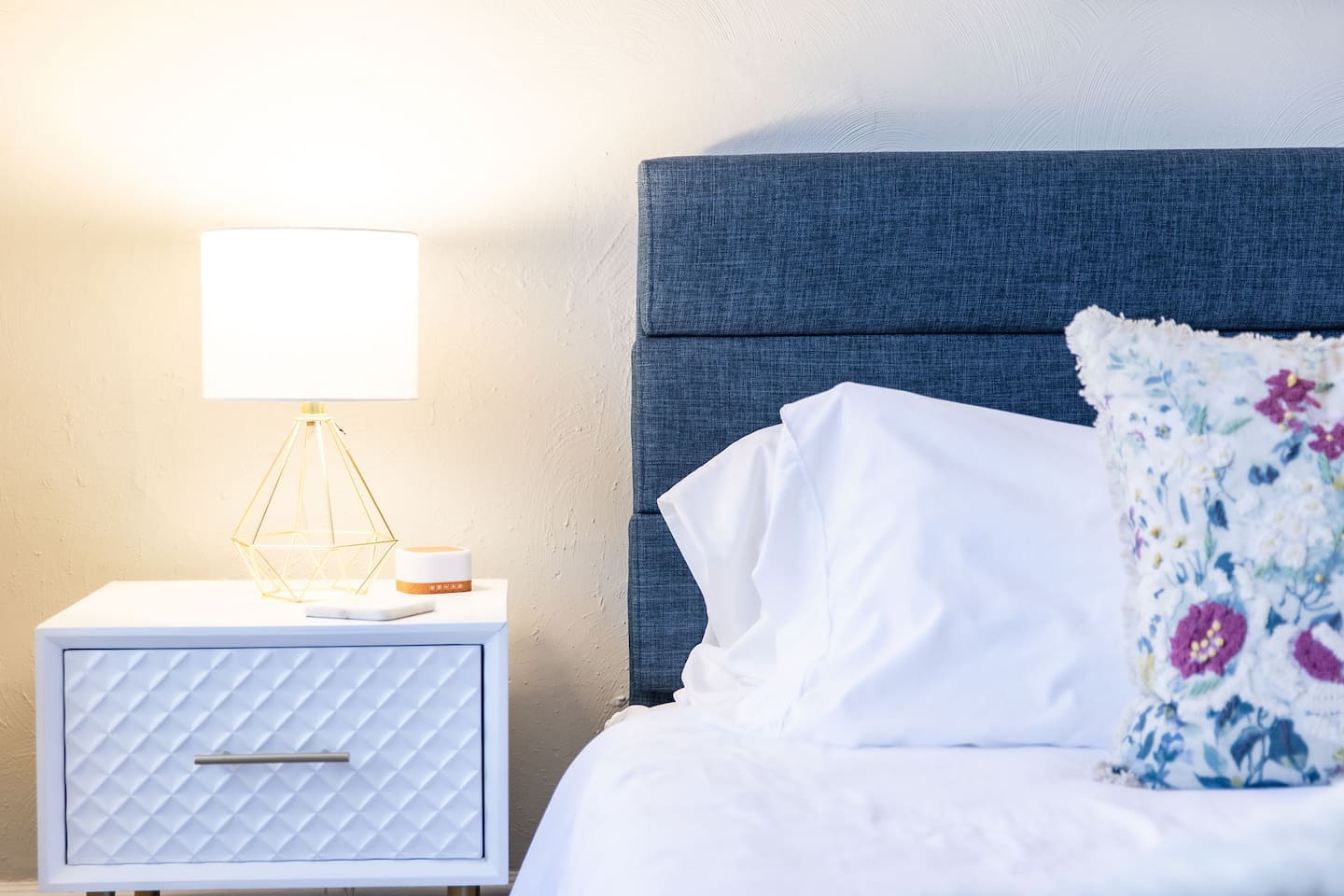 Bedside table and lamp.