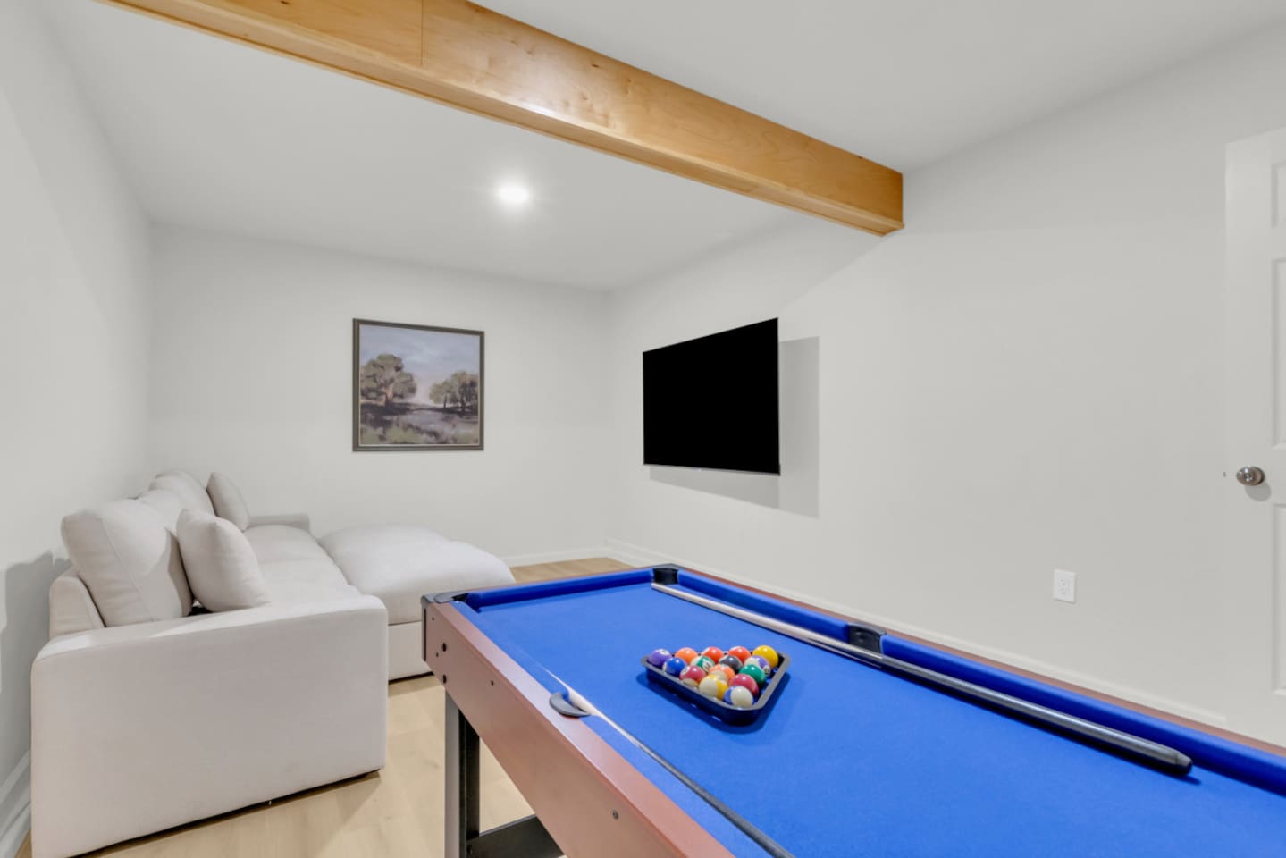 Private cinema/game room with full pool table setup, lounge sofa, and wall-mounted TV—great for groups, families, and long-term stays.