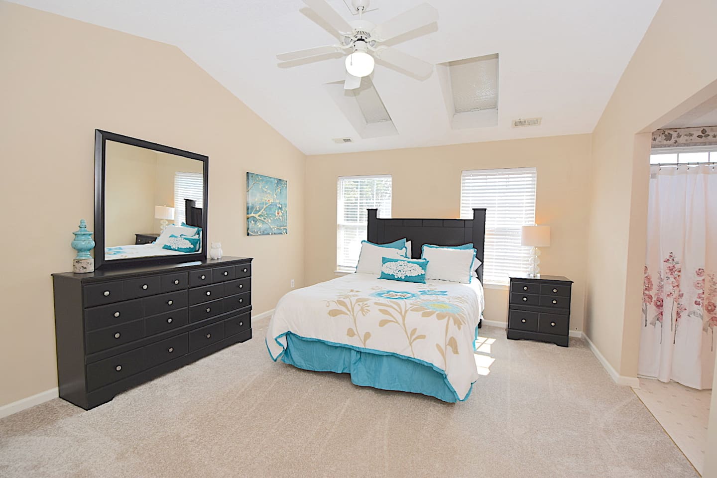 Upstairs master bedroom suite with a queen bed and walk-in closet