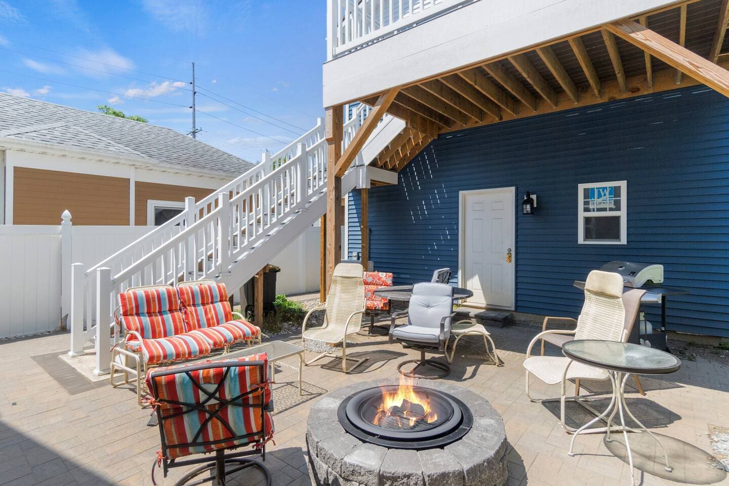 Backyard sitting area with a cozy fireplace, perfect for relaxing and enjoying the outdoors.