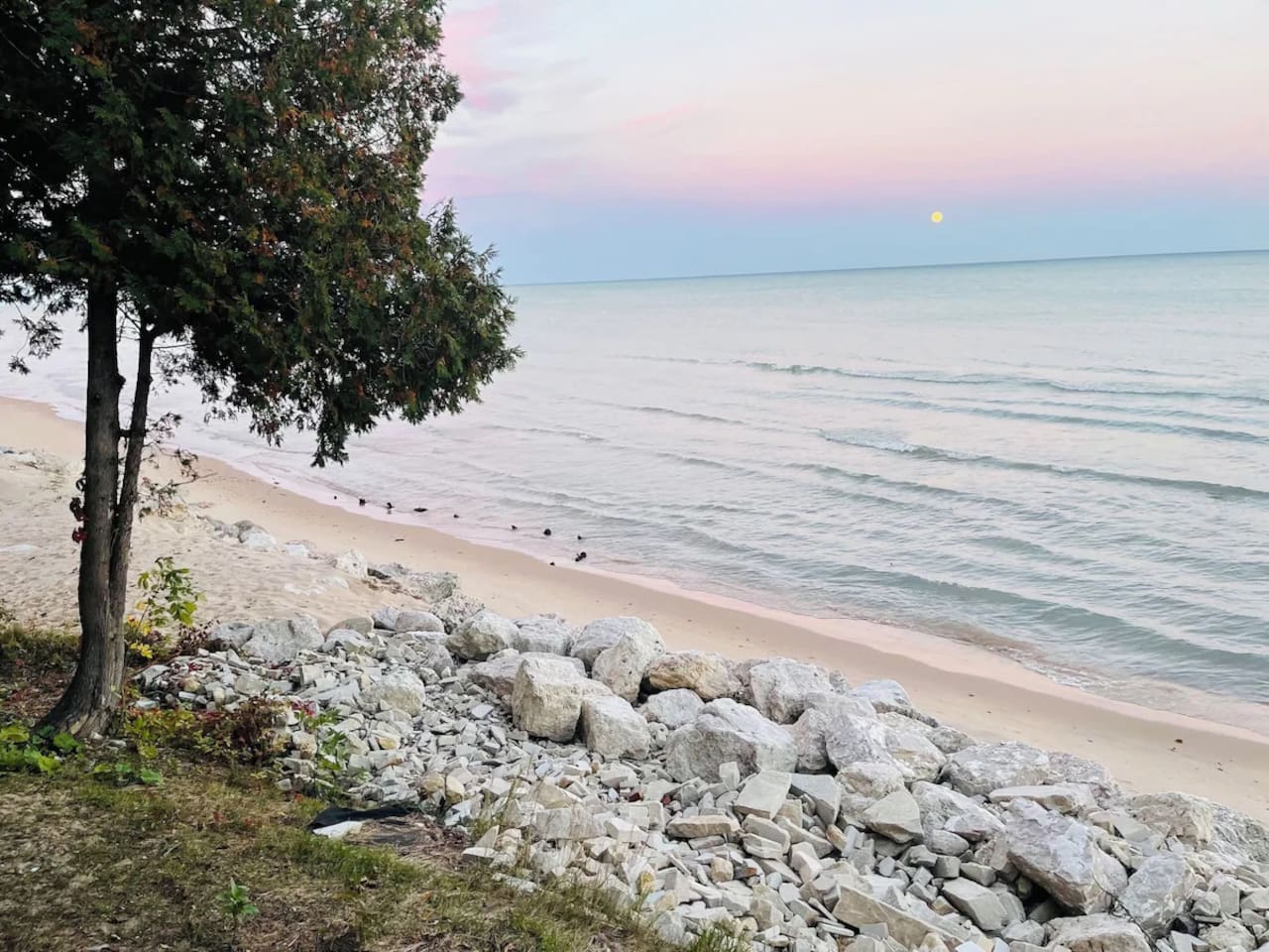 Peaceful shoreline w/ rocky edge & calm water just steps away