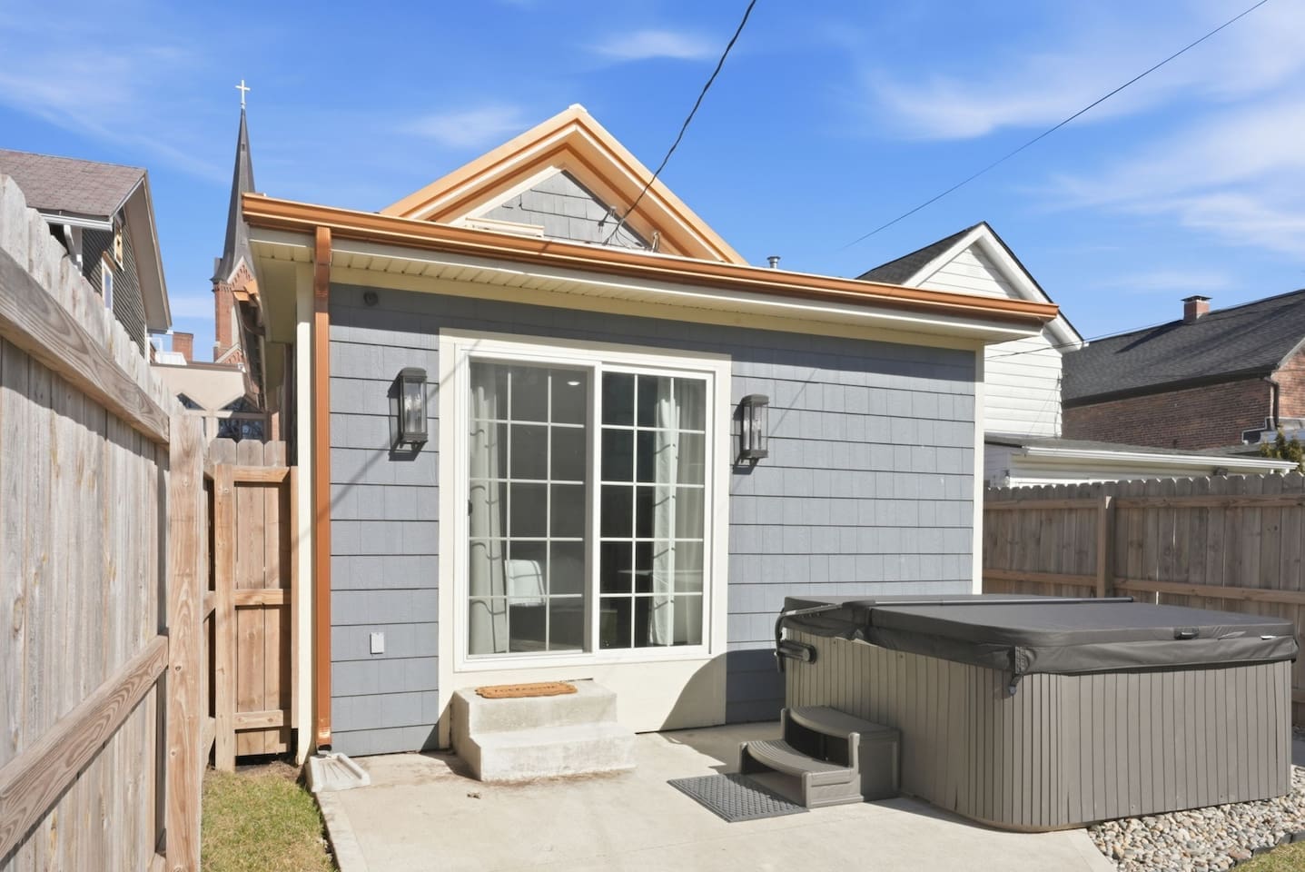 Cozy outdoor space with a hot tub and easy indoor access for seamless relaxation