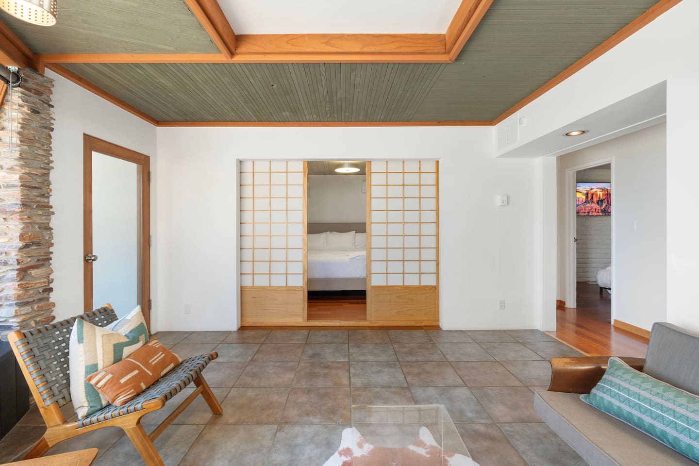 Serene lounge space with sliding shoji doors leading to a cozy bedroom retreat.