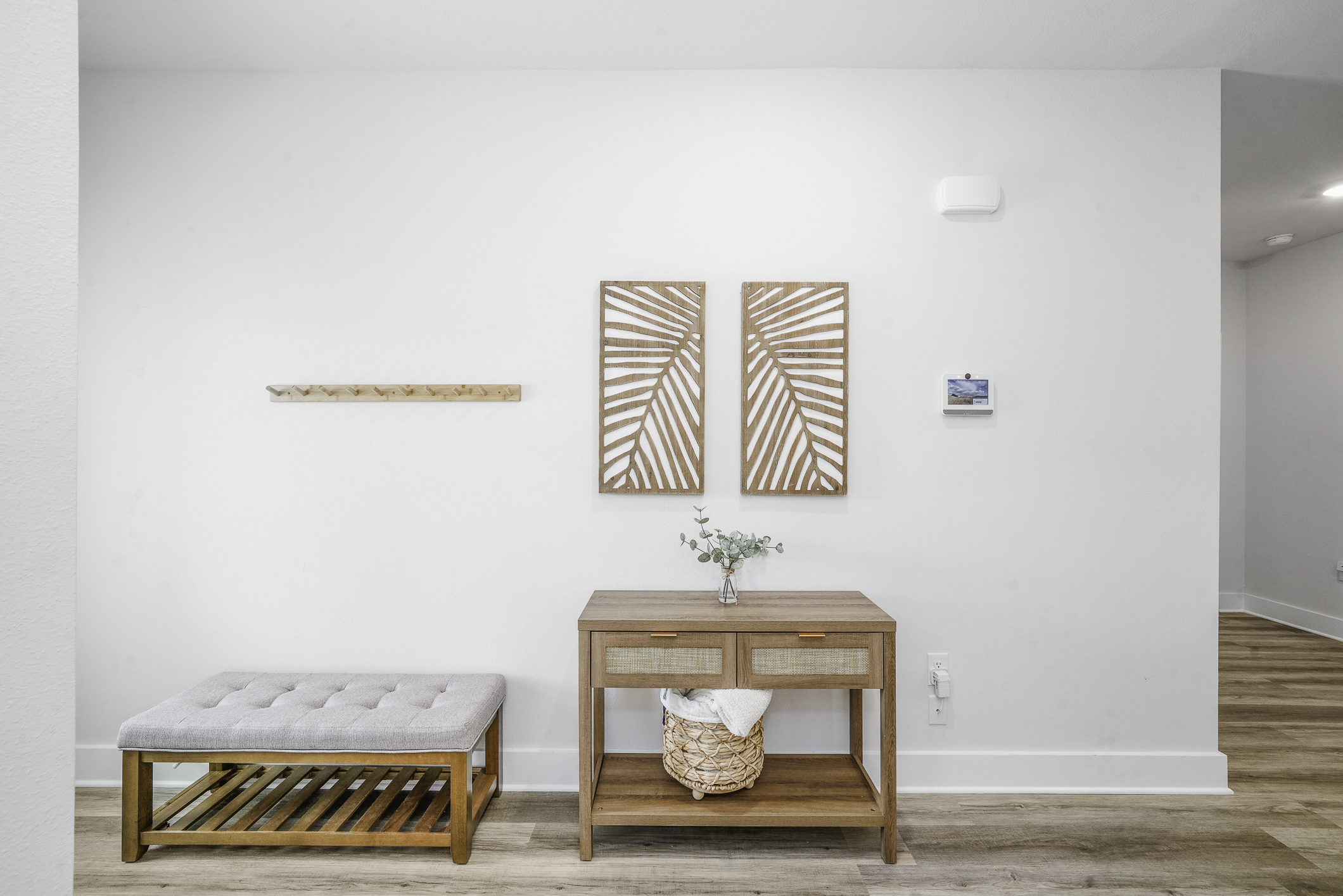 Bright and welcoming entryway featuring a cozy bench for changing shoes and stylish decor