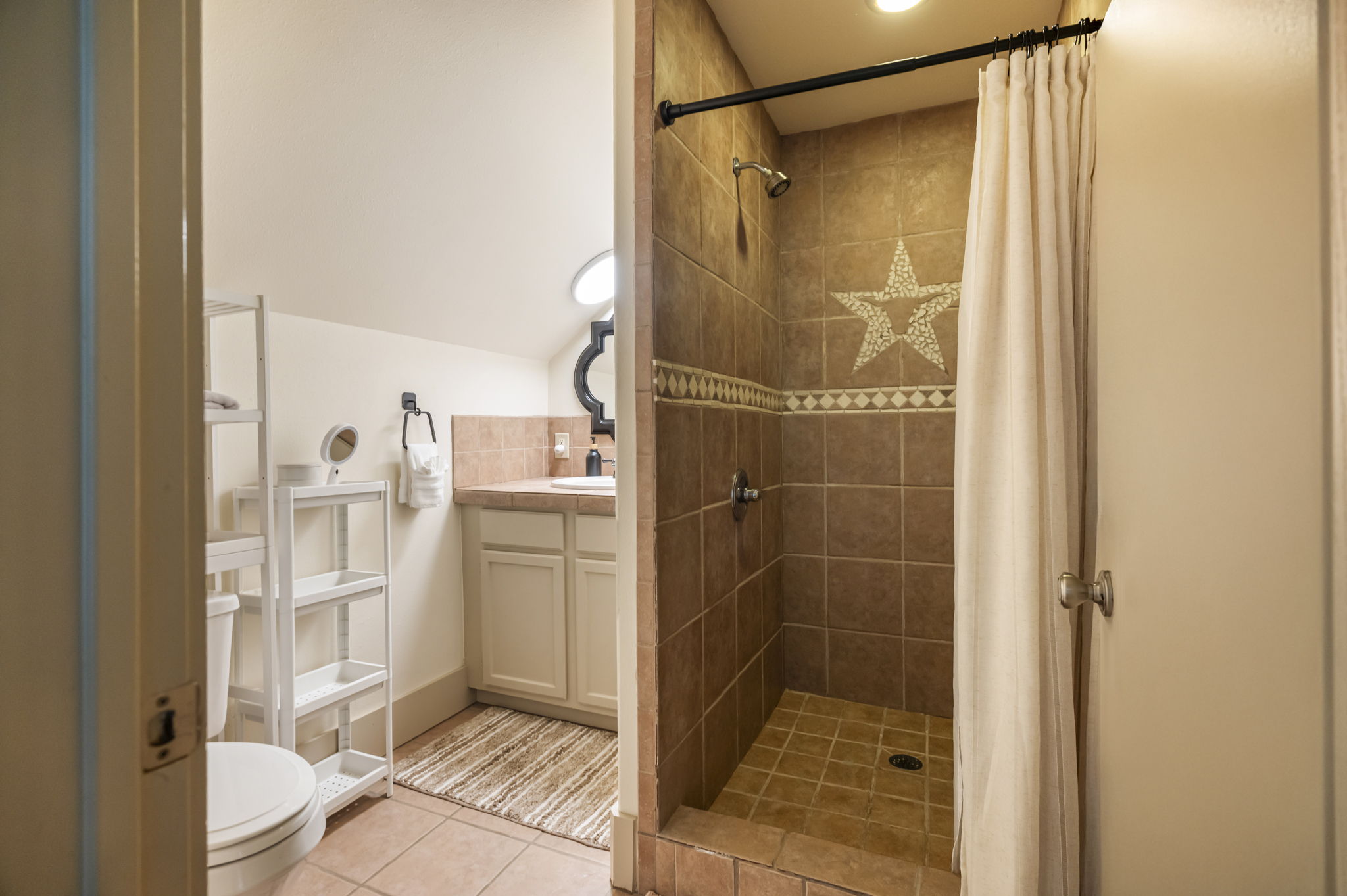A full bathroom offers a single sink, shower, and toilet, providing everything needed for a self-contained stay.