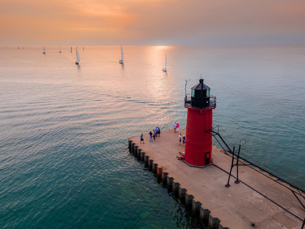 Strolling along South Haven's riverwalk to reach the iconic red lighthouse on the pier is a must-do activity for guests staying at Benny’s on Broadway.