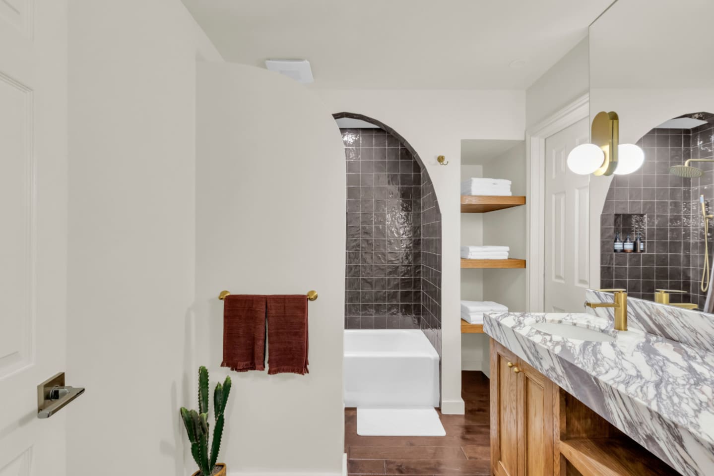 Guest bathroom featuring a full bathtub and stocked with fresh towels and essential bath amenities, offering a comfortable and convenient space for daily use.
