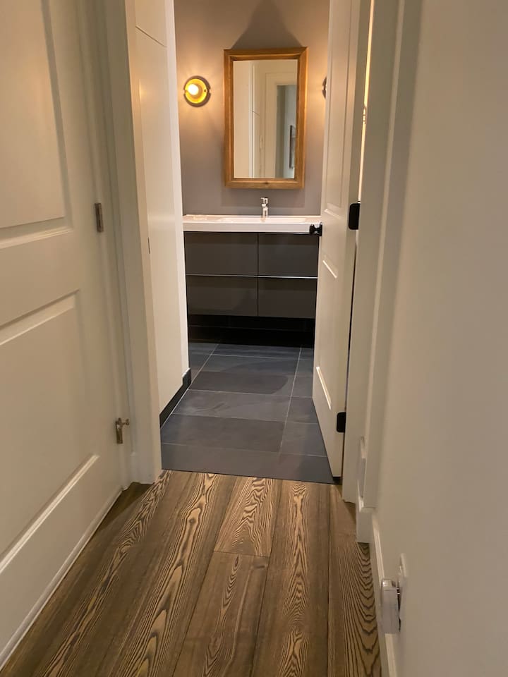 Short hallway that leads to bathroom and the laundry and dryer