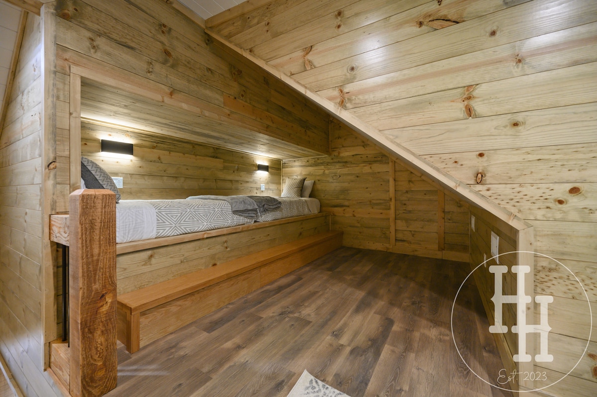 Two twin bunk beds with individual lights and plugs for electronics