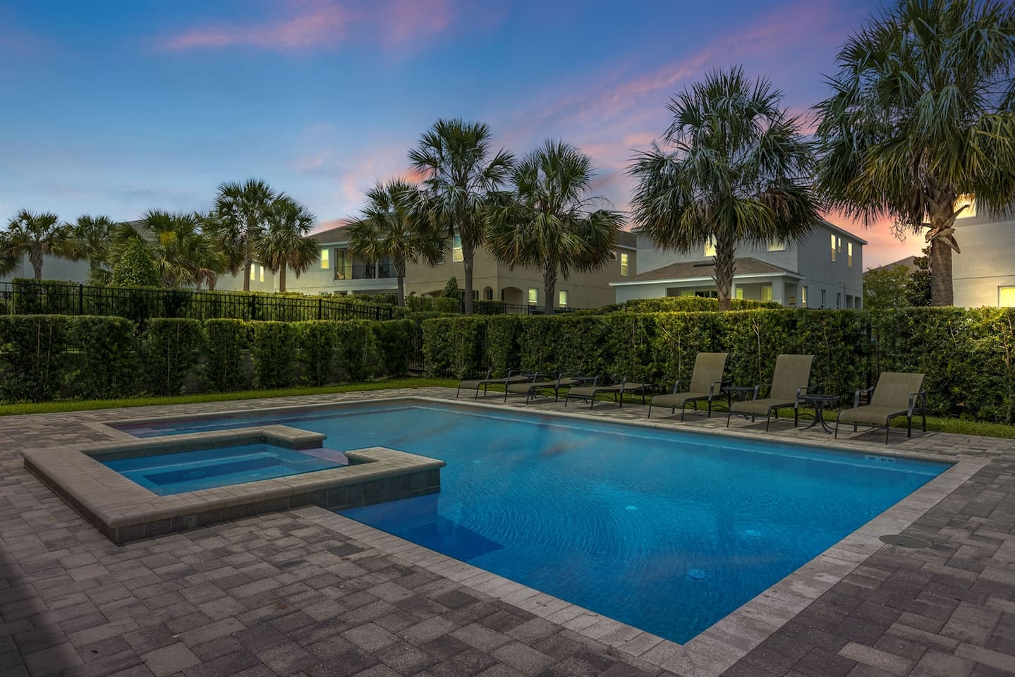 Experience evening tranquility by the poolside, where sunbathing chairs await amidst lush greenery. The warm glow of sunset casts a magical ambiance, complemented by soft lighting, creating a perfect setting for relaxation and memorable moments.