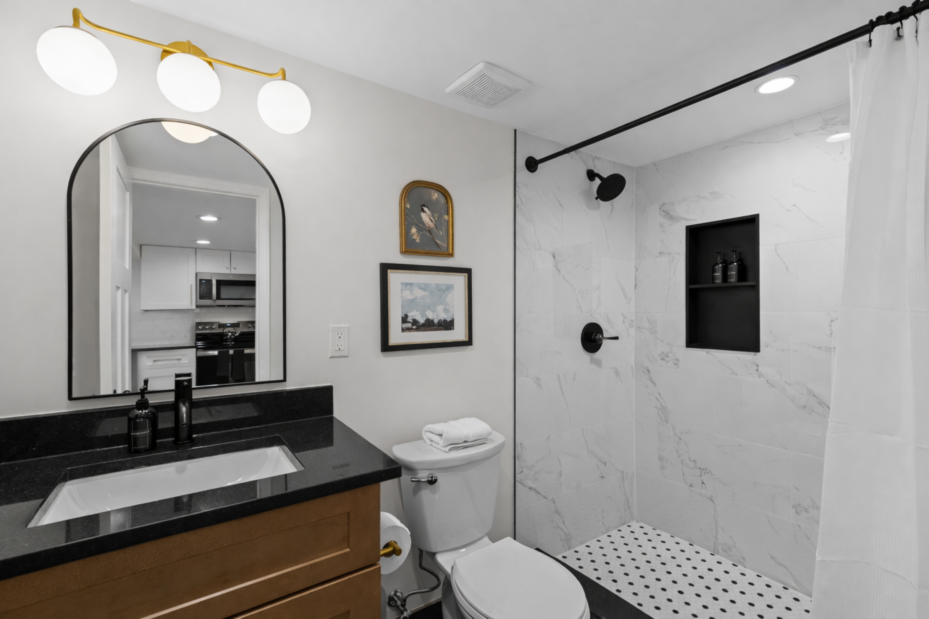 Modern, spa-inspired bathroom with a walk-in shower, sleek finishes, soft lighting, and fresh towels—clean, bright, and relaxing.