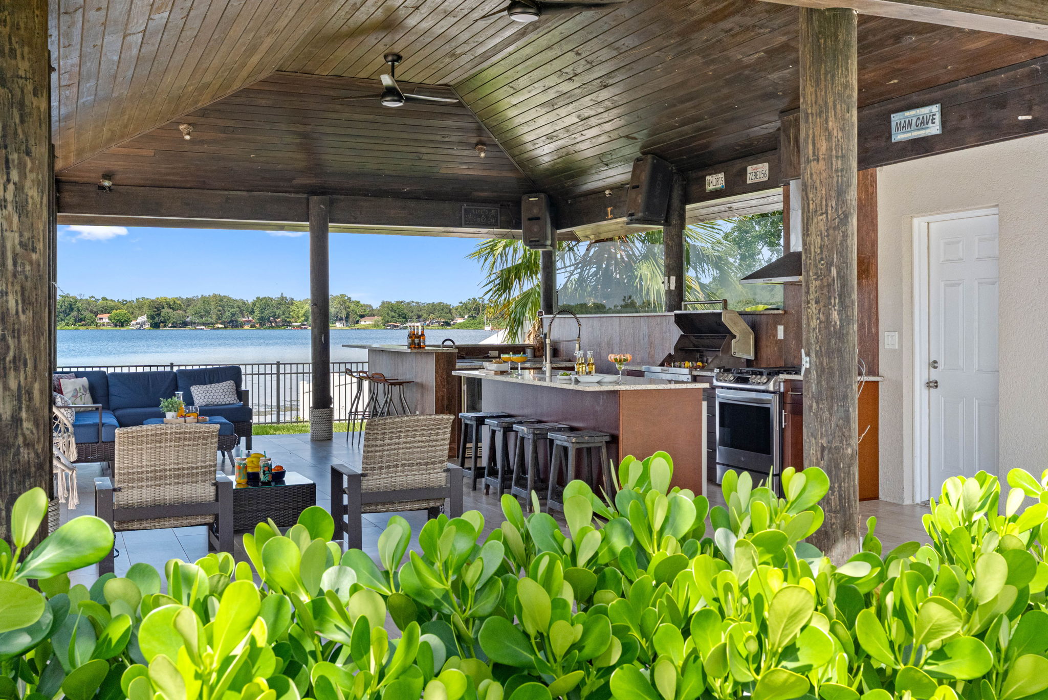 Host unforgettable gatherings with an outdoor kitchen, bar, cozy seating, and breathtaking scenery right by the water’s edge.