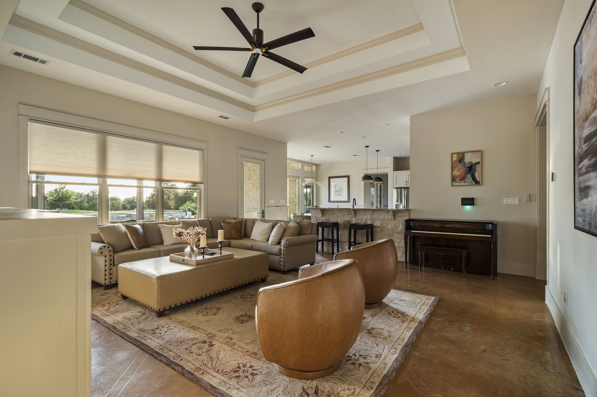 A classic wooden piano and large windows that fill the space with natural light