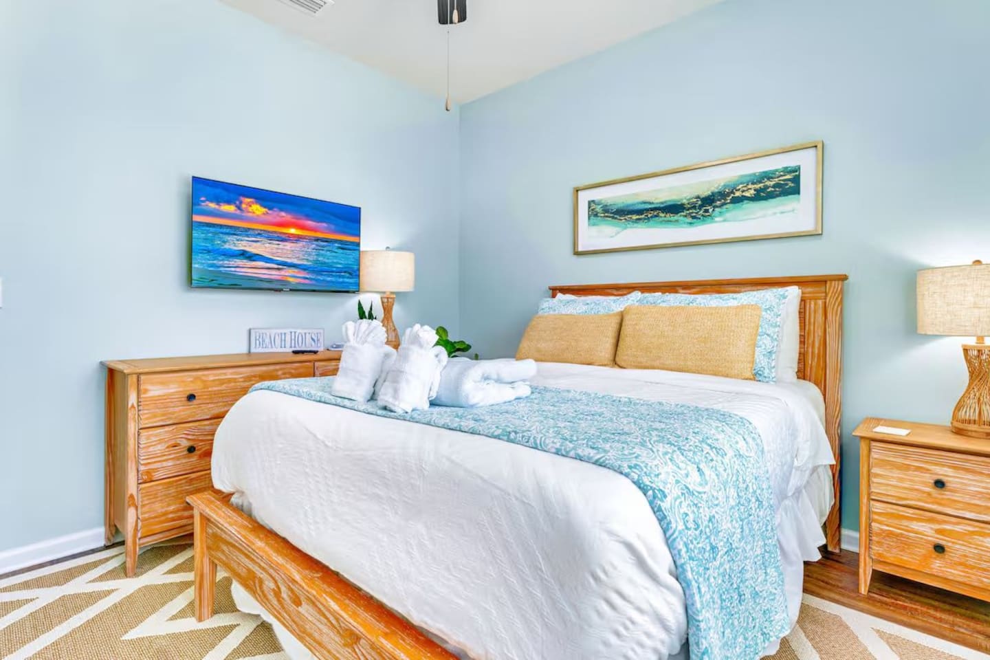 Bedroom 3: Queen bedroom featuring ceiling fan, bedside lamp, plush linens, dresser and Smart TV