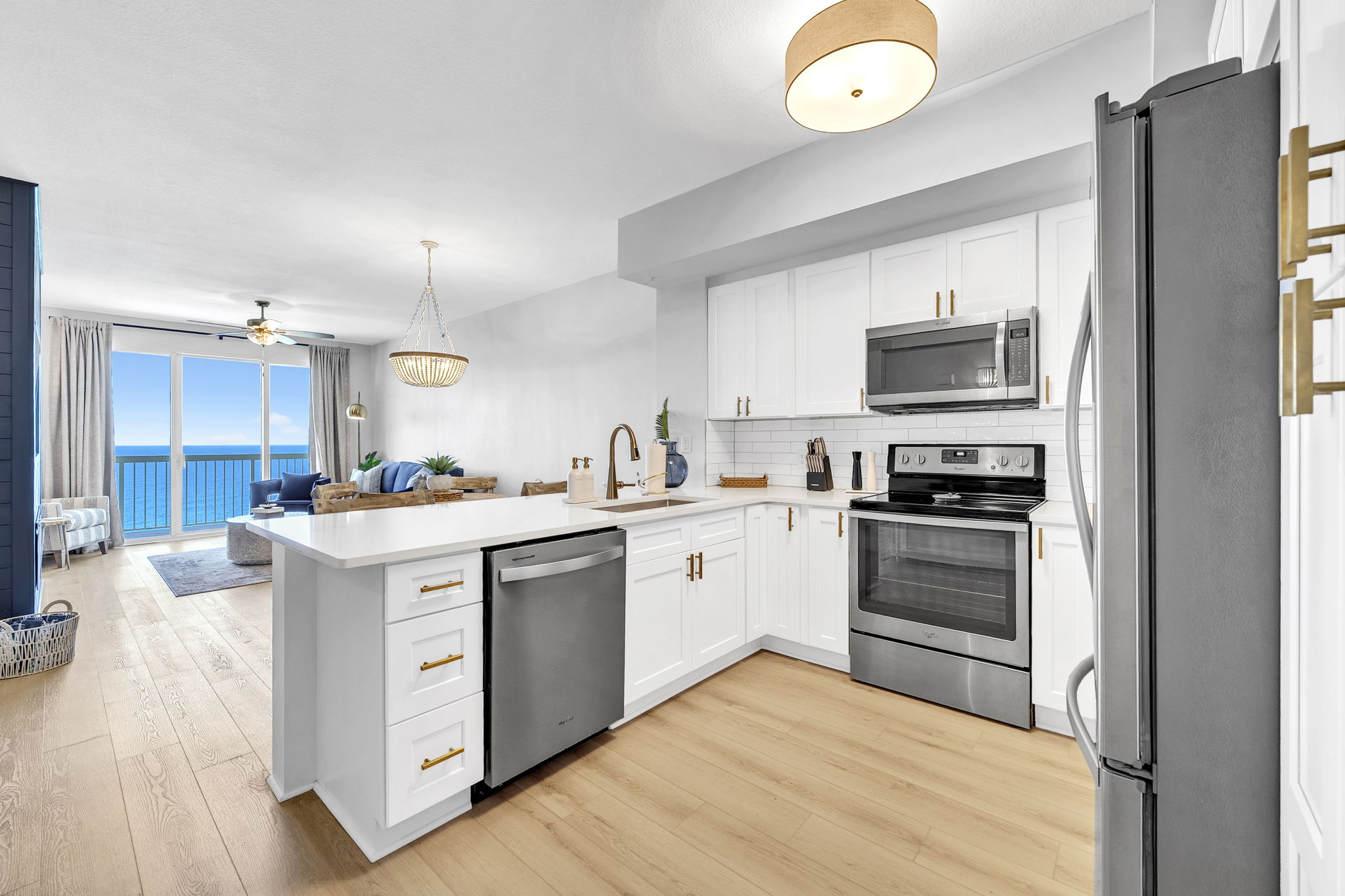A fully updated kitchen featuring stainless steel appliances, including a full-size refrigerator, oven, microwave, and dishwasher—everything you need for easy, stress-free meals during your stay.