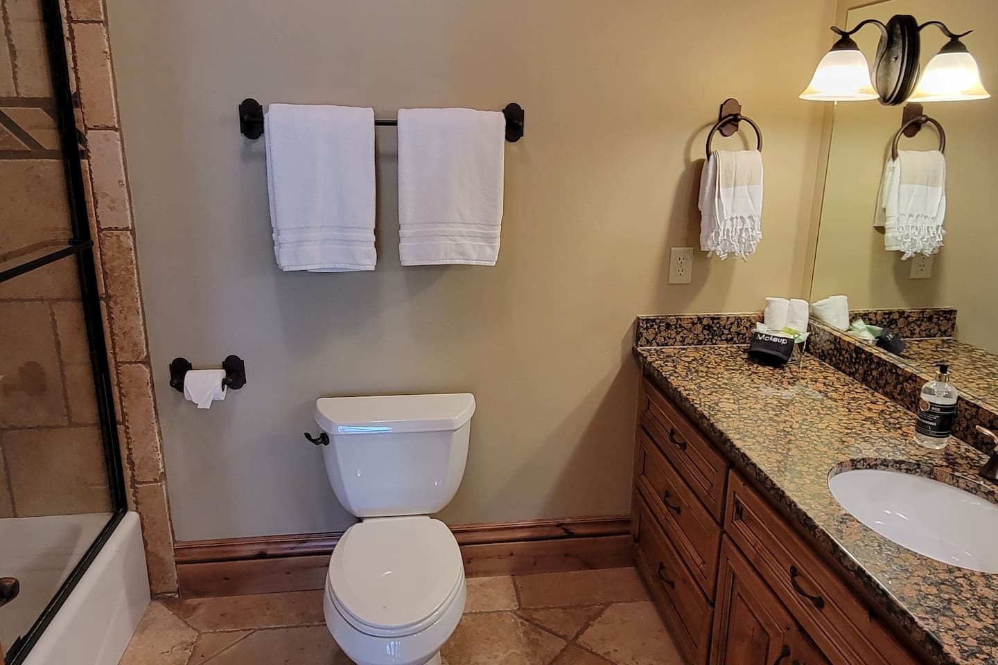 This well-appointed bathroom is maintained to the highest standards of cleanliness and comfort, featuring fresh, fluffy towels, a spacious vanity, and a convenient tub/shower combination—perfect for relaxing and refreshing during your stay.