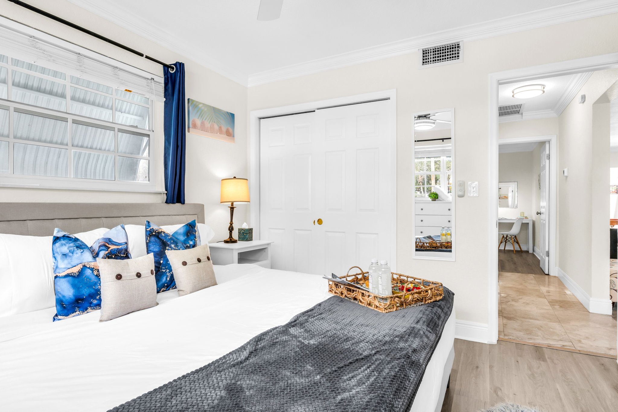 Unwind in the serene primary suite with a king bed, soft linens, and sunlit windows—your peaceful escape after a day at the beach.