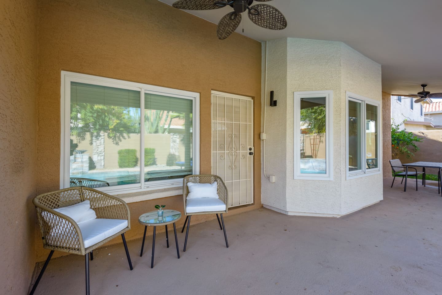 Covered outdoor seating area with window views and easy access from the home.