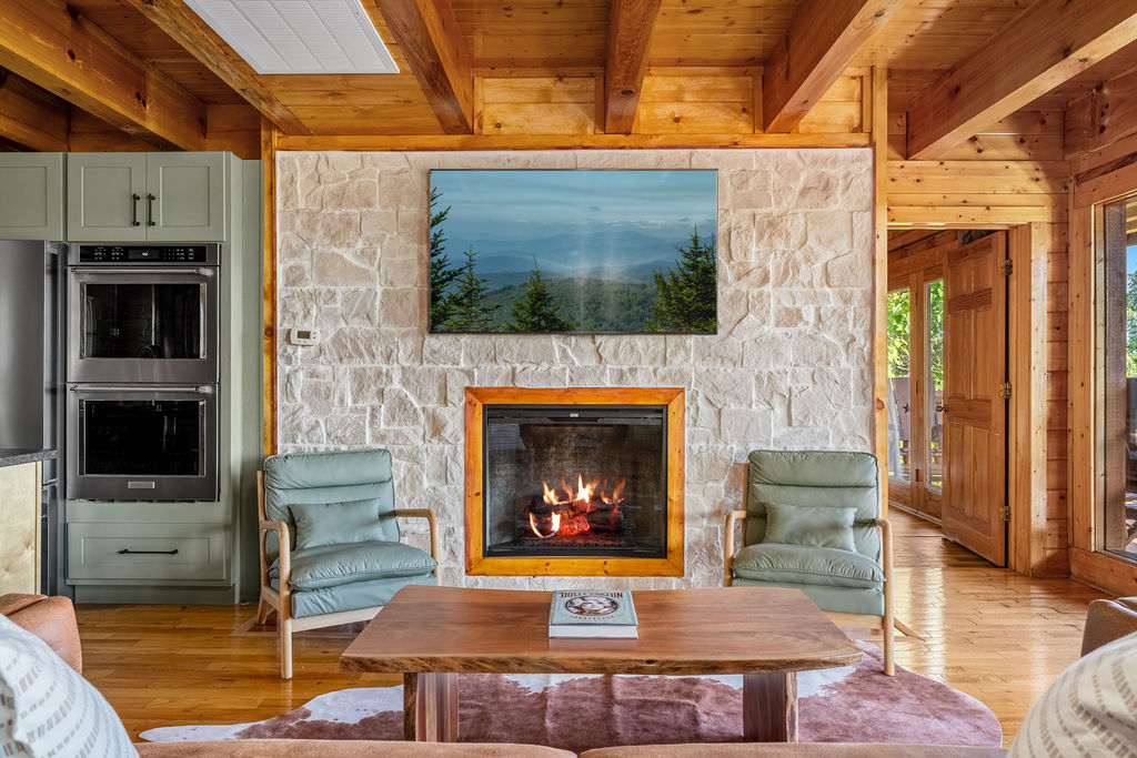Cozy up by the electric fireplace with a good book in hand, wrapped in the warmth of panoramic mountain views.