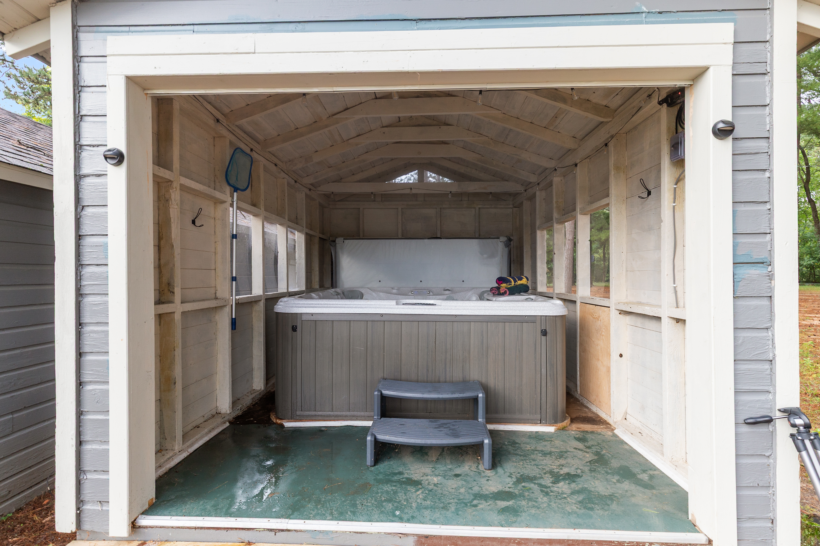 Relax in the hot tub while taking in serene views of Little Silver Lake.